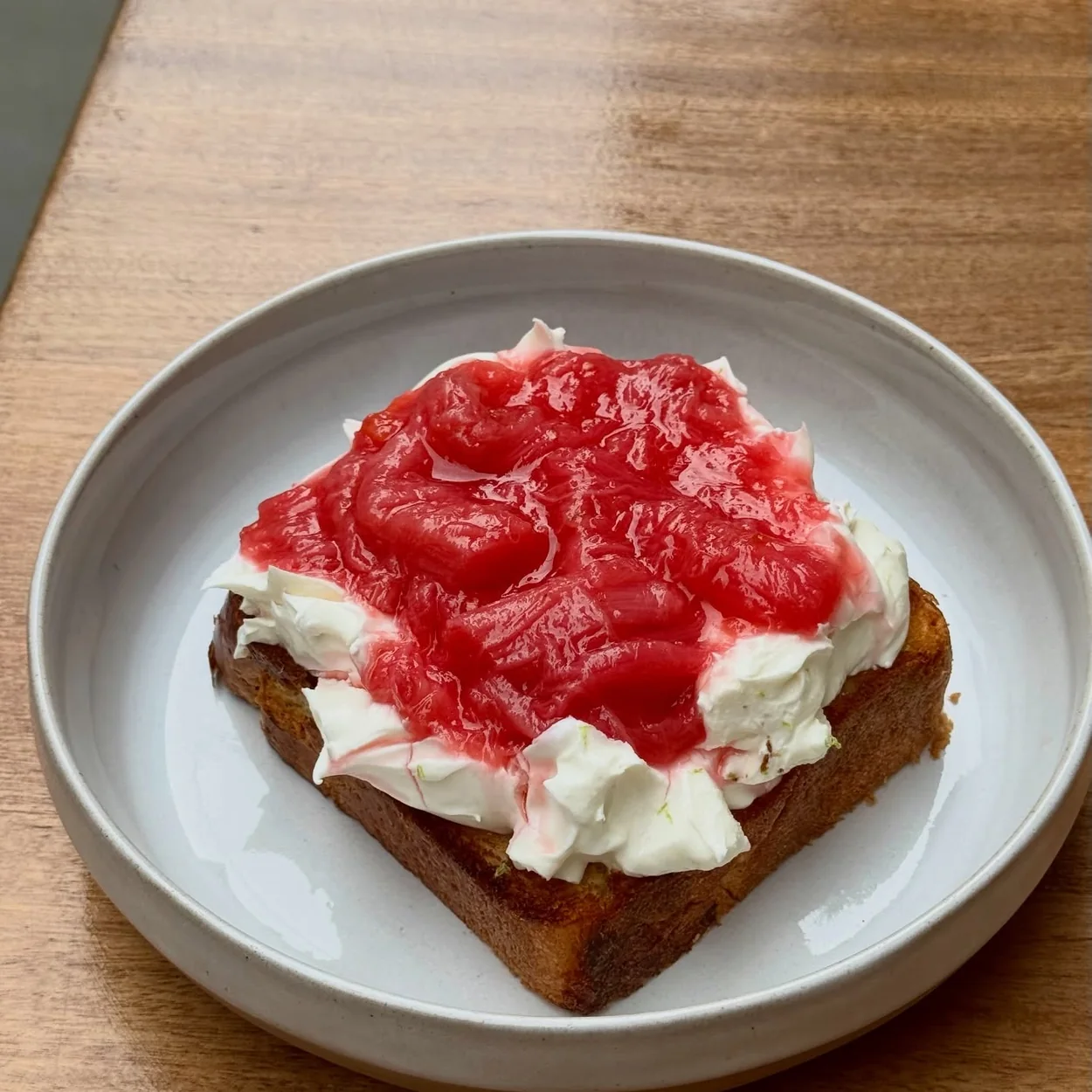 Abuelo brunch plate of toast with cream and strawberry compote