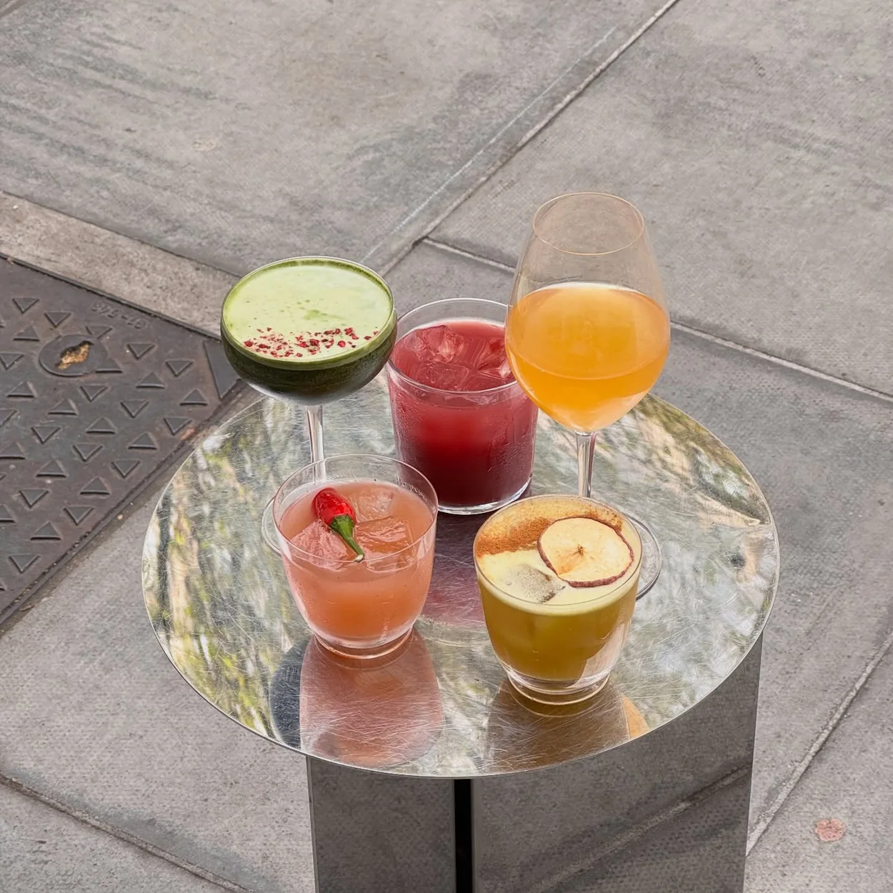 Abuelo natural wine and cocktails on a table outside the cafe