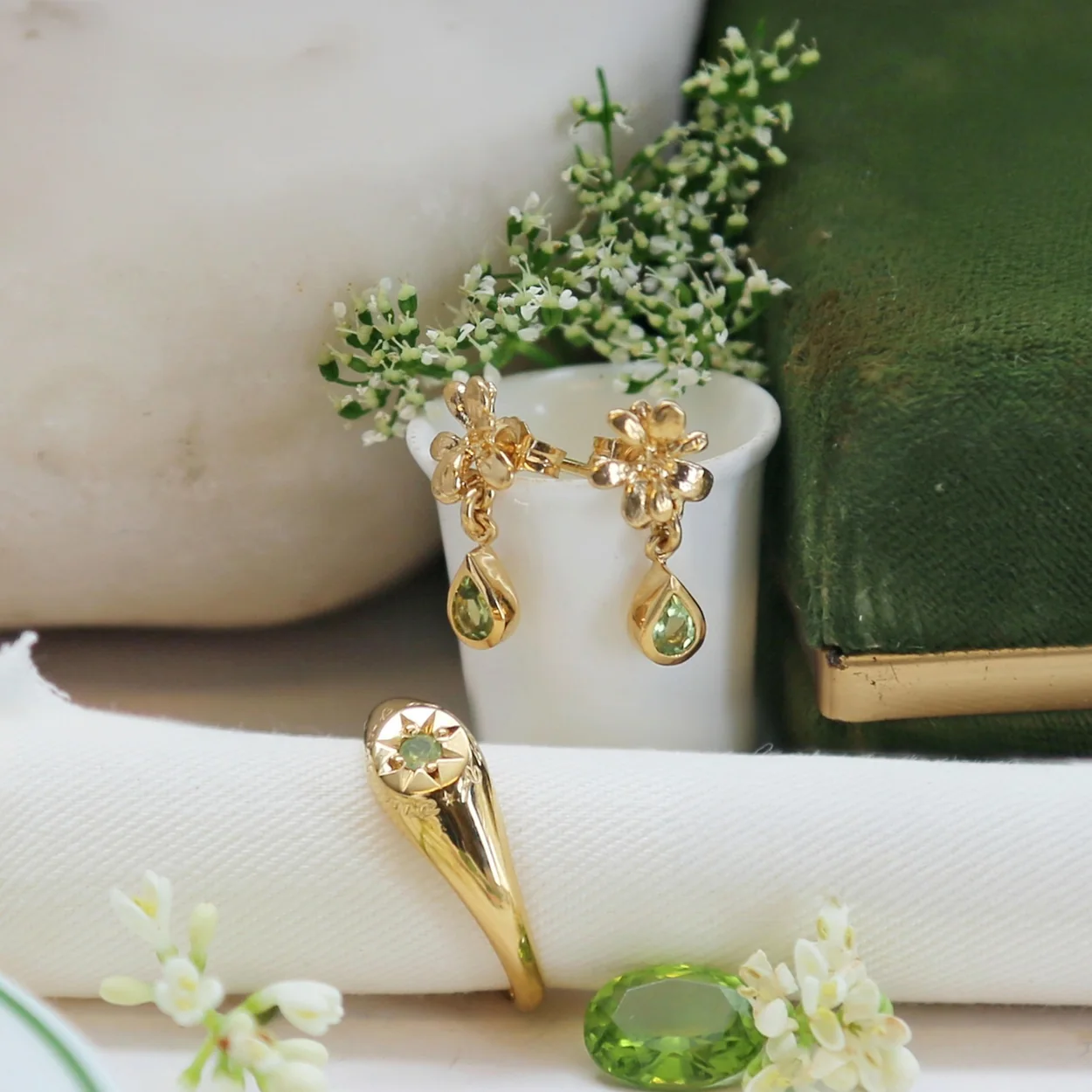 Alex Monroe gemstone earrings and ring still life with flowers