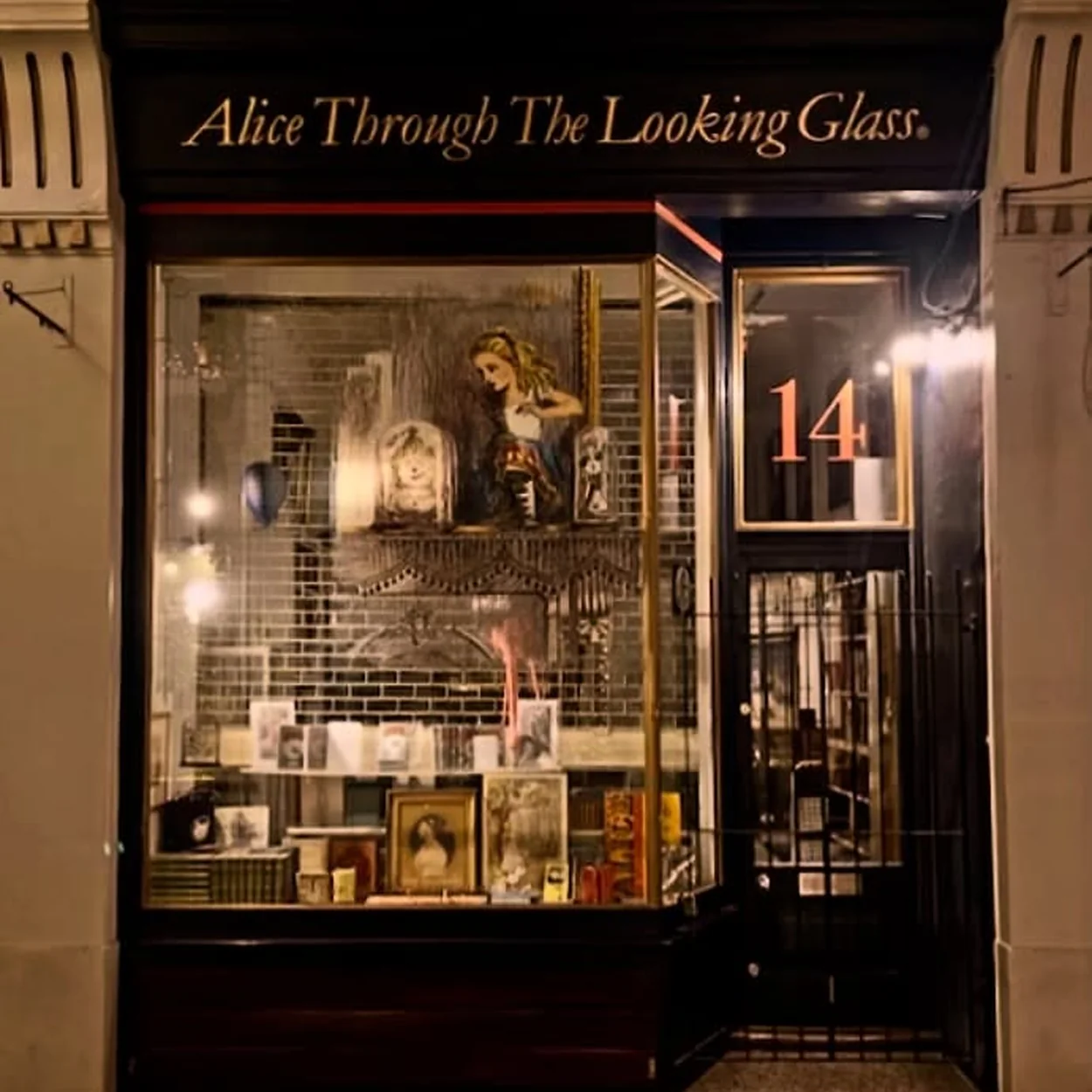 Alice Through the Looking Glass shop at number 14 Cecil Court lit up in the evening