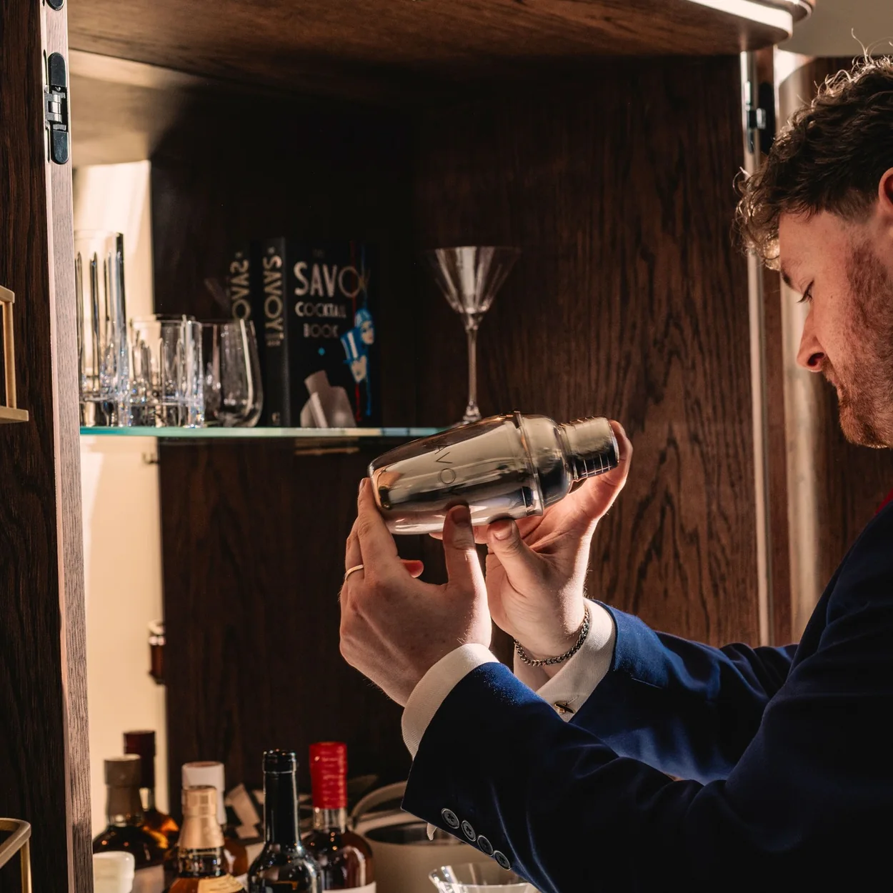 American Bar at The Savoy bartender shaking a cocktail behind the bar
