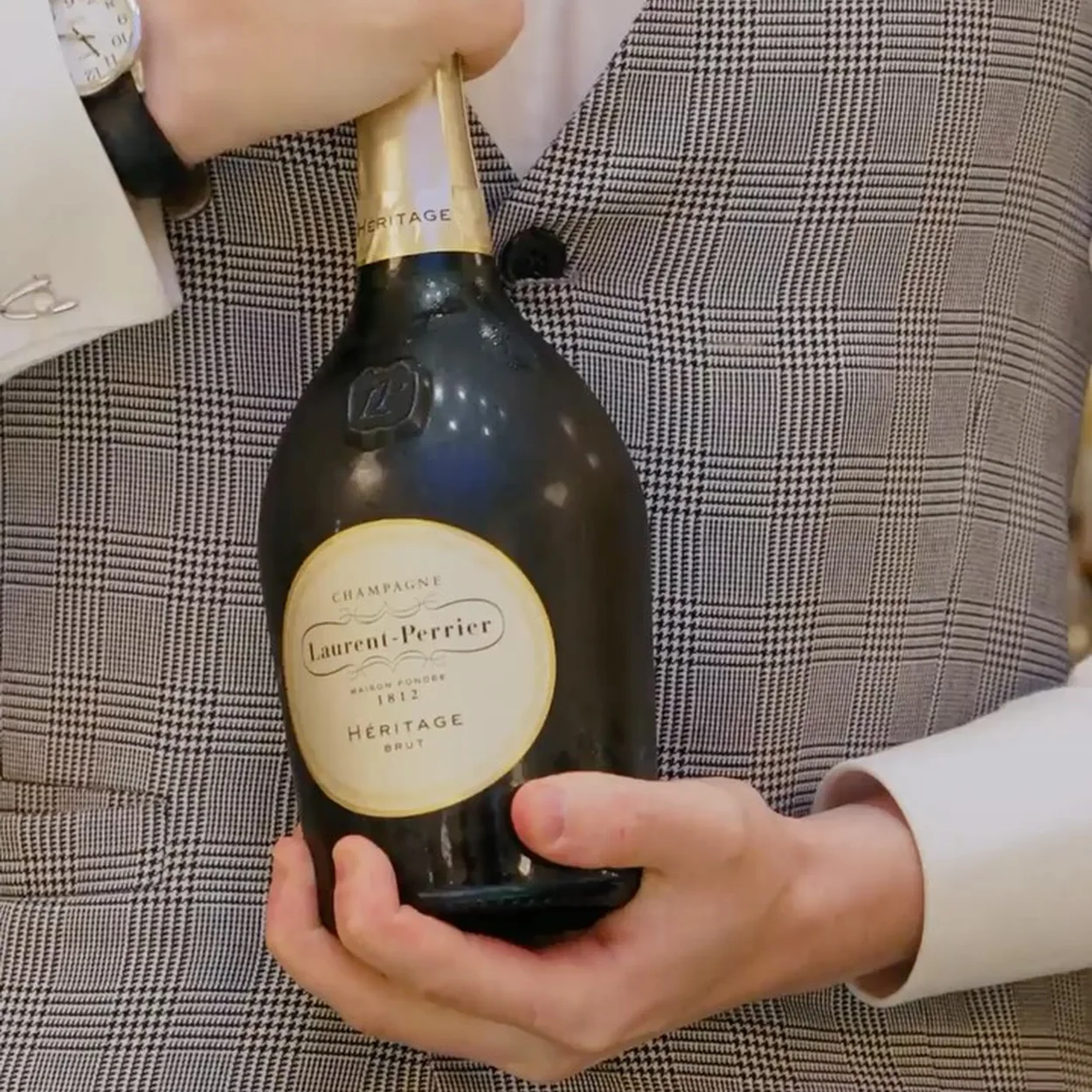 American Bar at The Savoy waiter presenting a bottle of champagne
