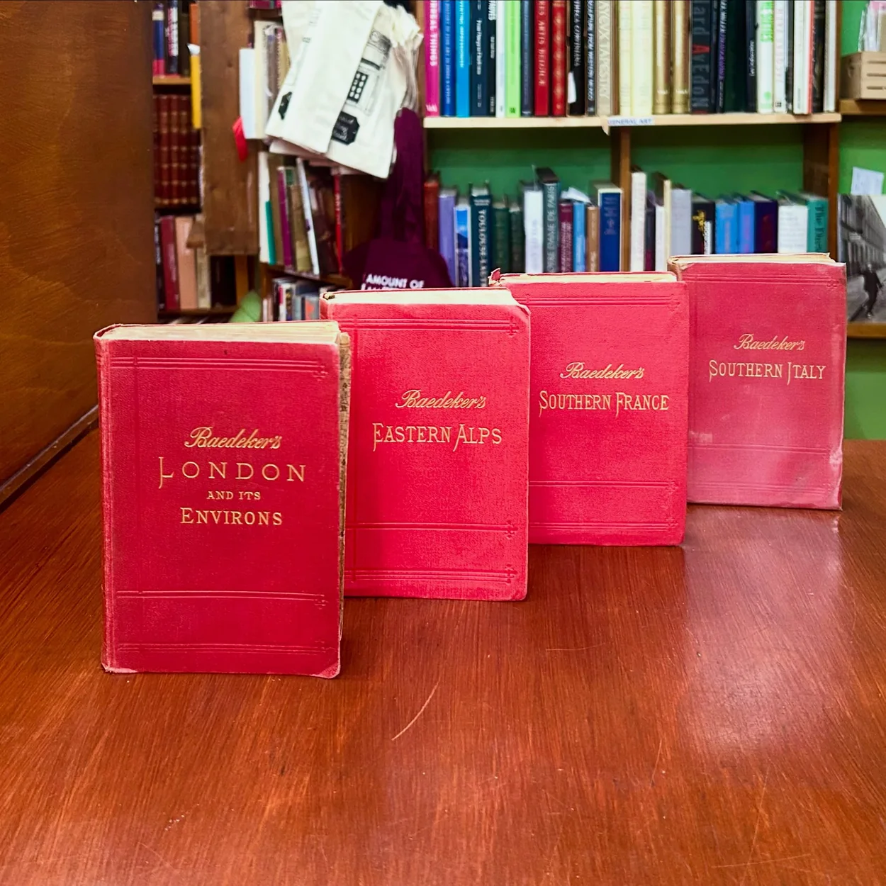 Any Amount of Books row of red Baedeker guides on the shop table