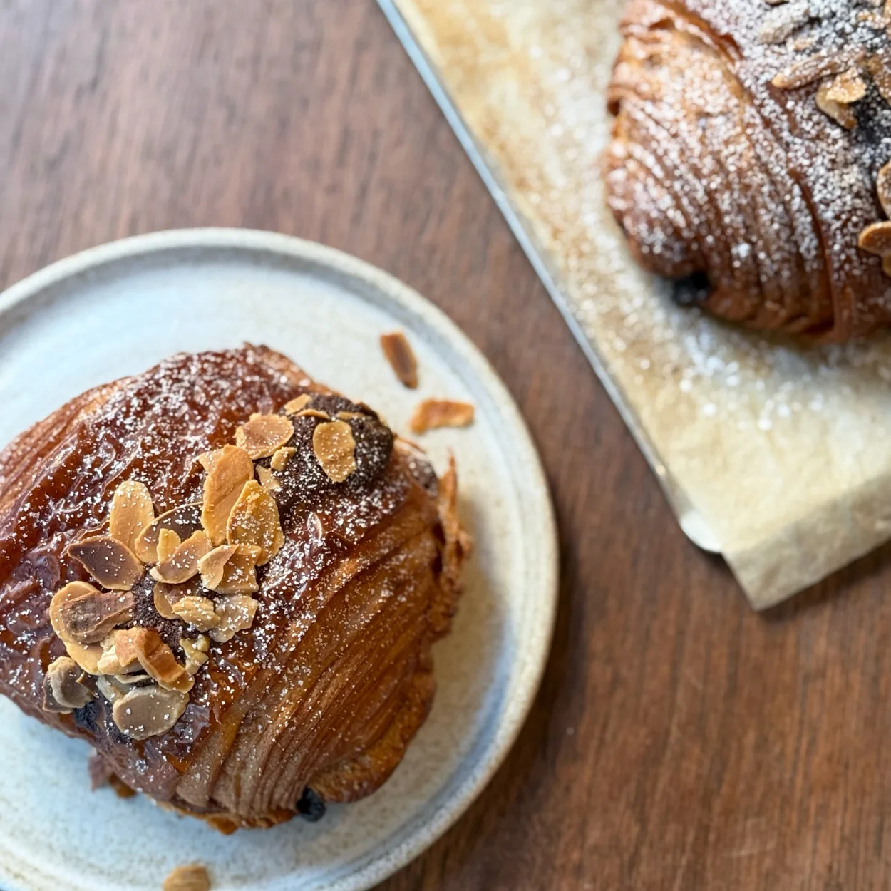 Arôme Bakery almond croissant dusted with icing sugar
