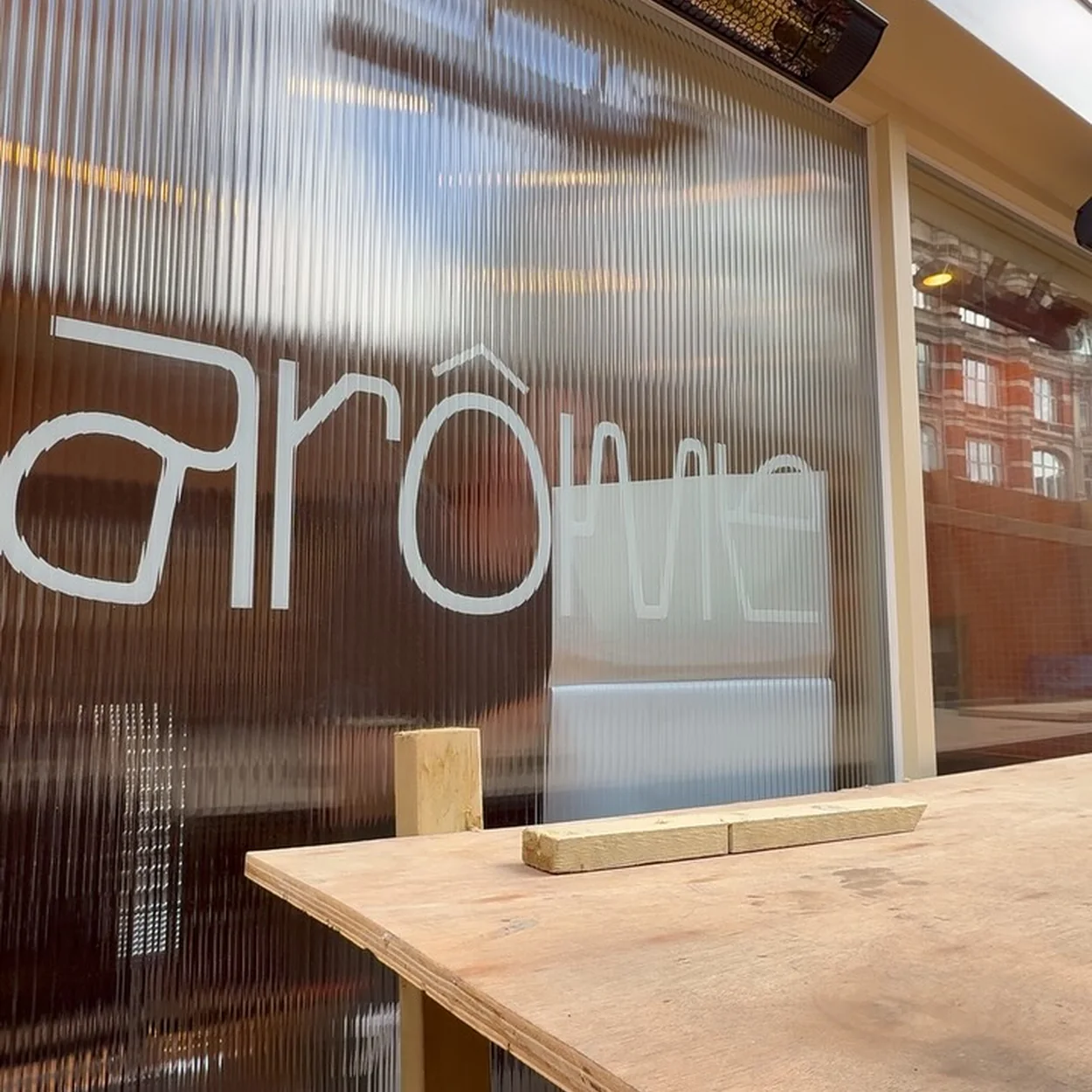 Arôme Bakery window sign seen from inside the shop