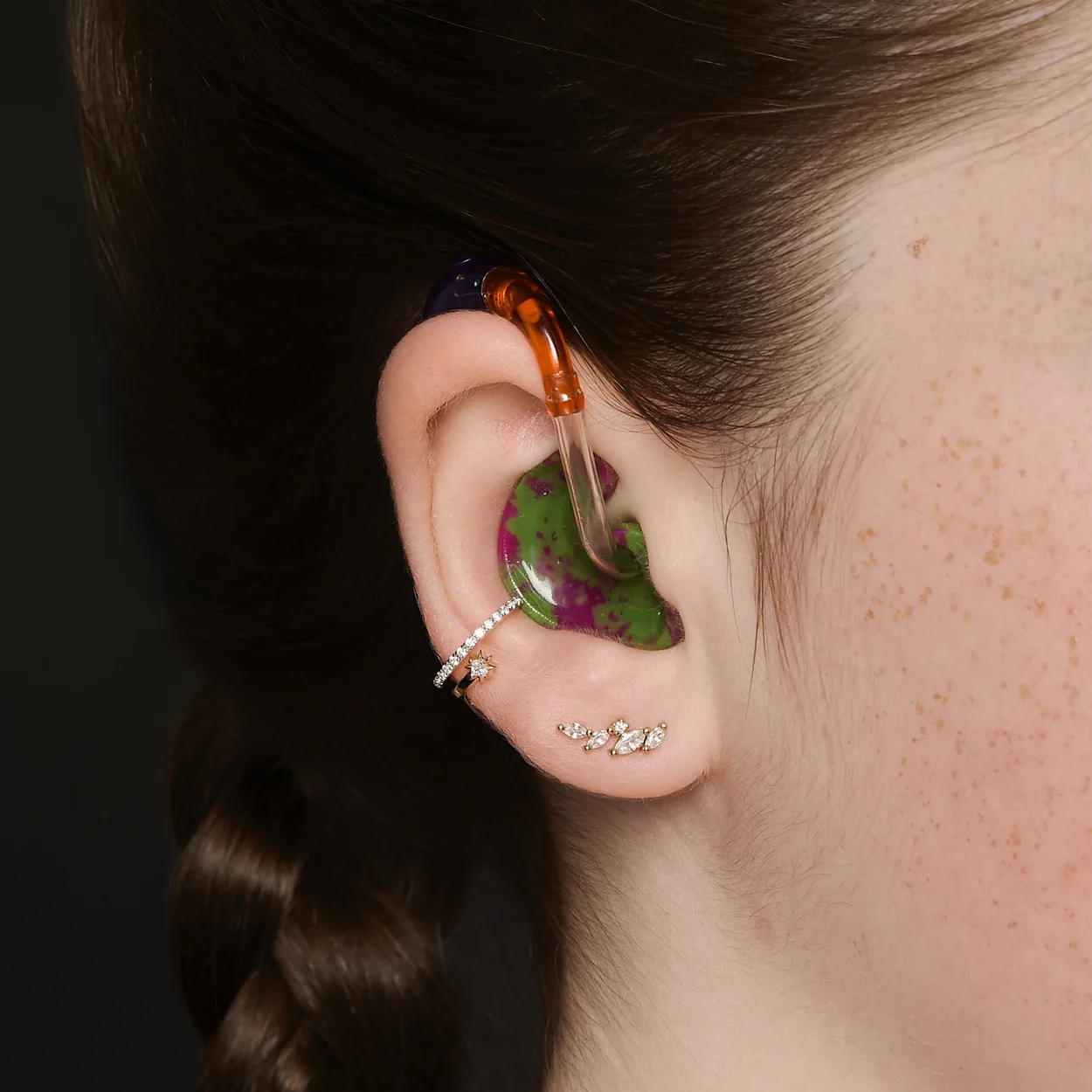 Astrid & Miyu ear piercing with gold studs and decorative cuff