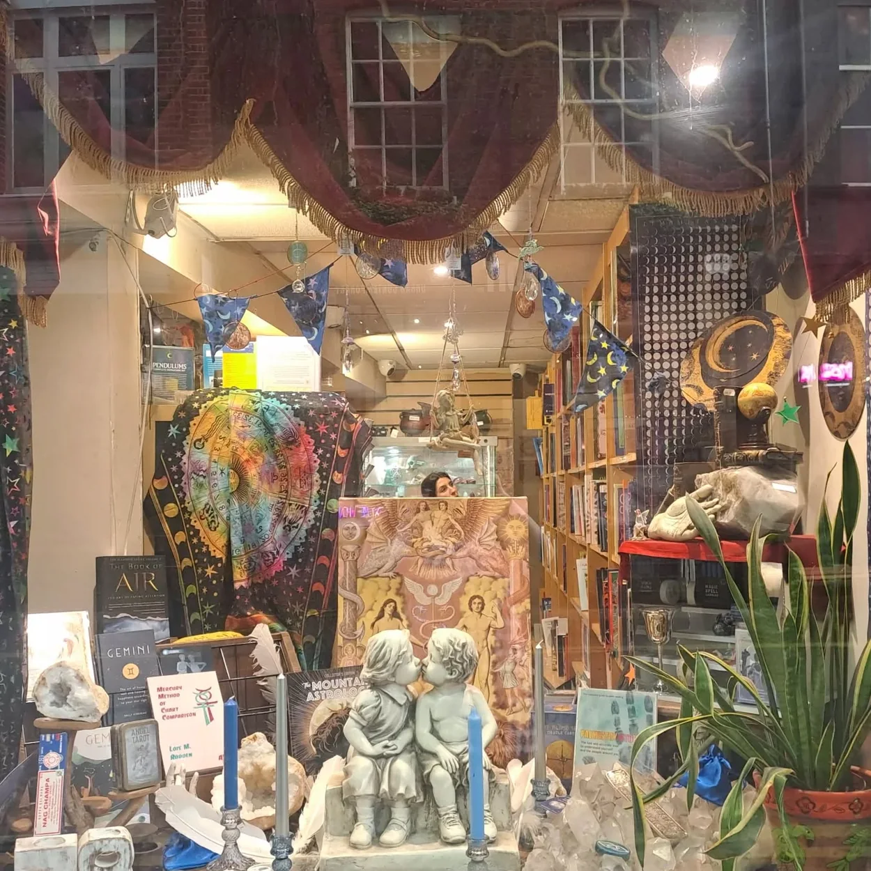 The Astrology Shop window display with crystals, prints and plants