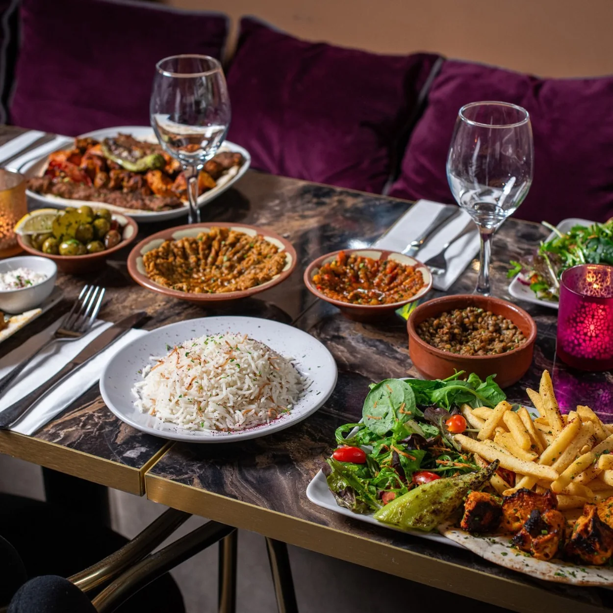 Bab Mansour dining table laid with mezze, rice and grilled dishes