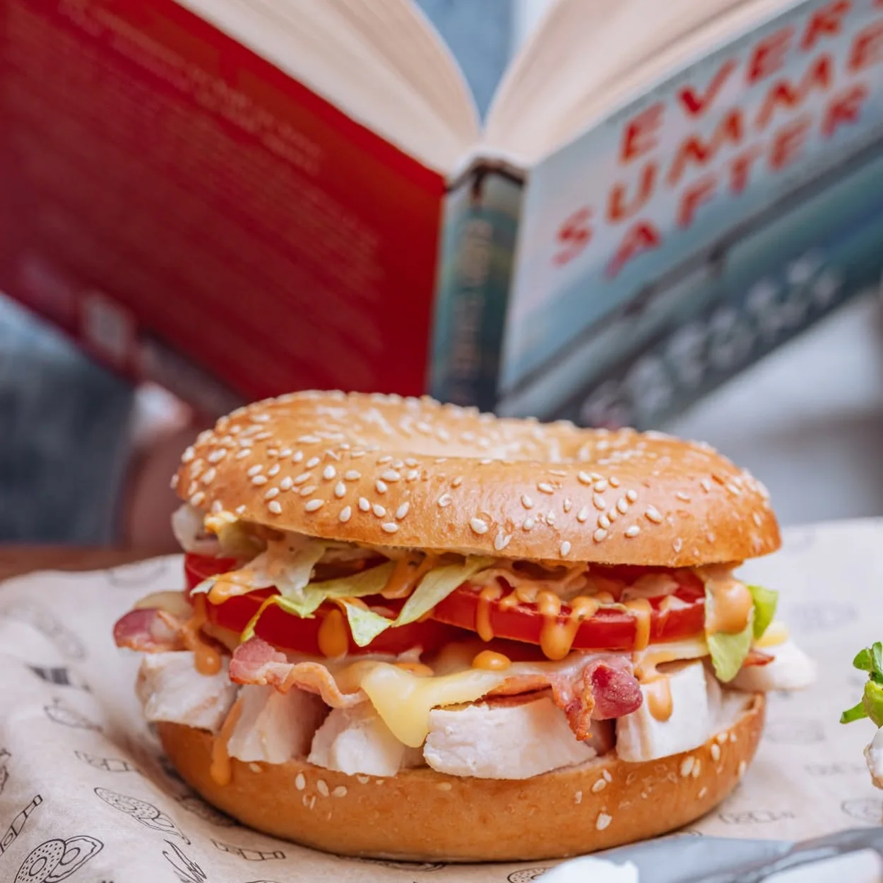 Bagel Factory chicken and salad bagel on branded paper