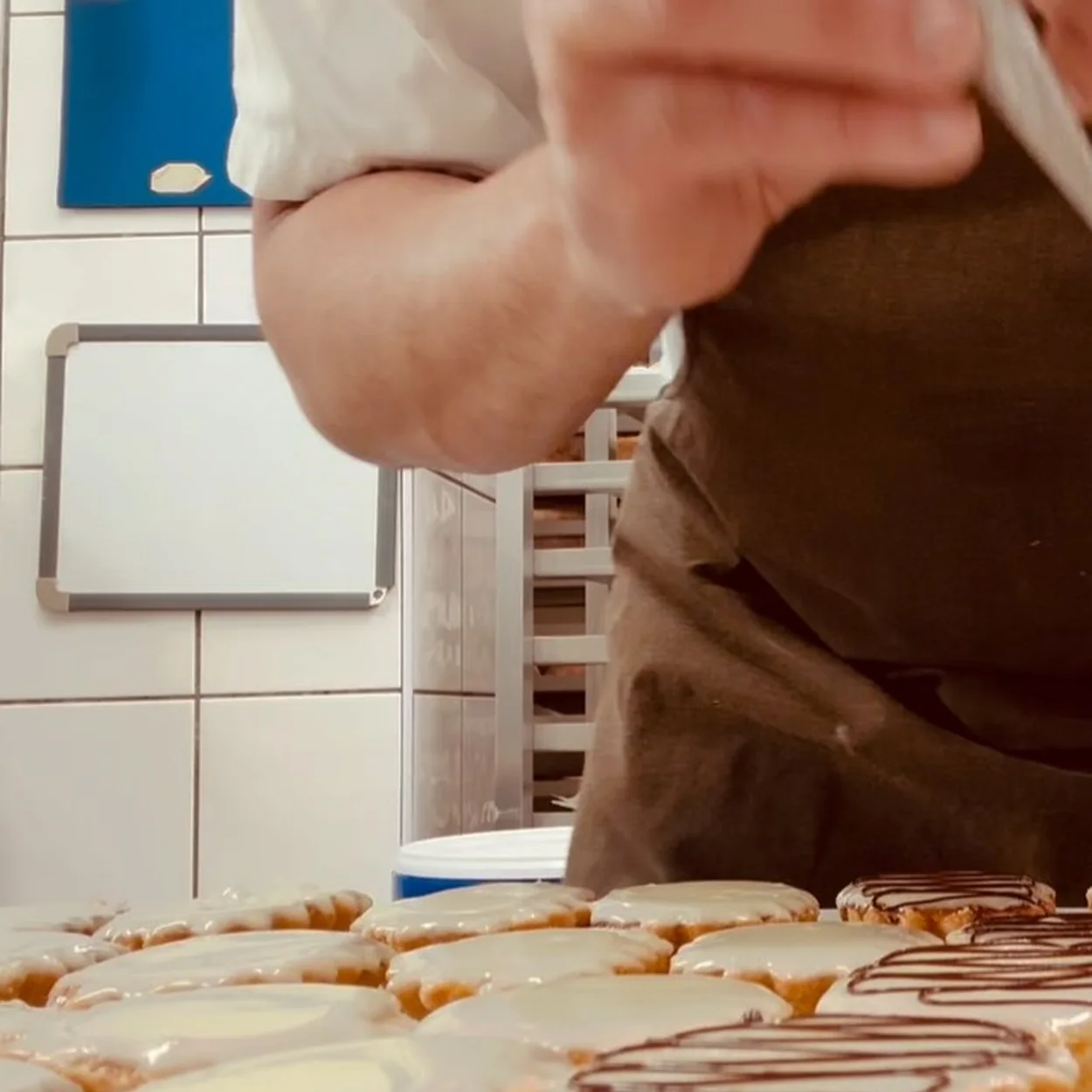 Bageriet baker finishing glazed pastries in the Rose Street kitchen