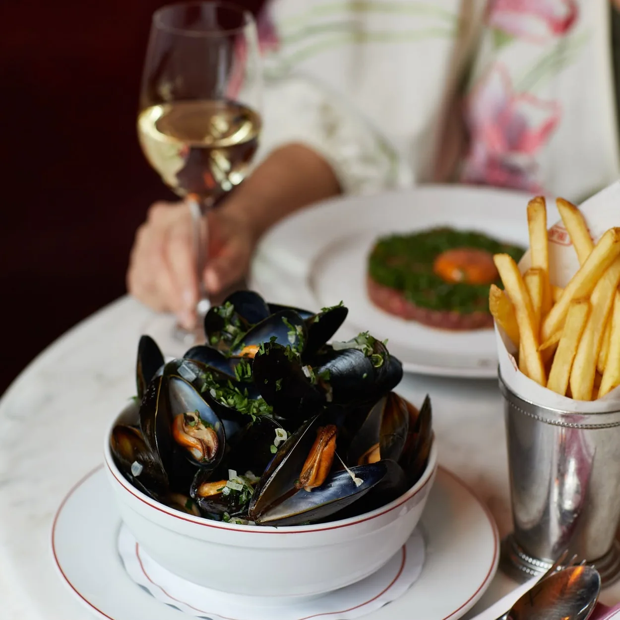 Balthazar moules frites with a glass of white wine