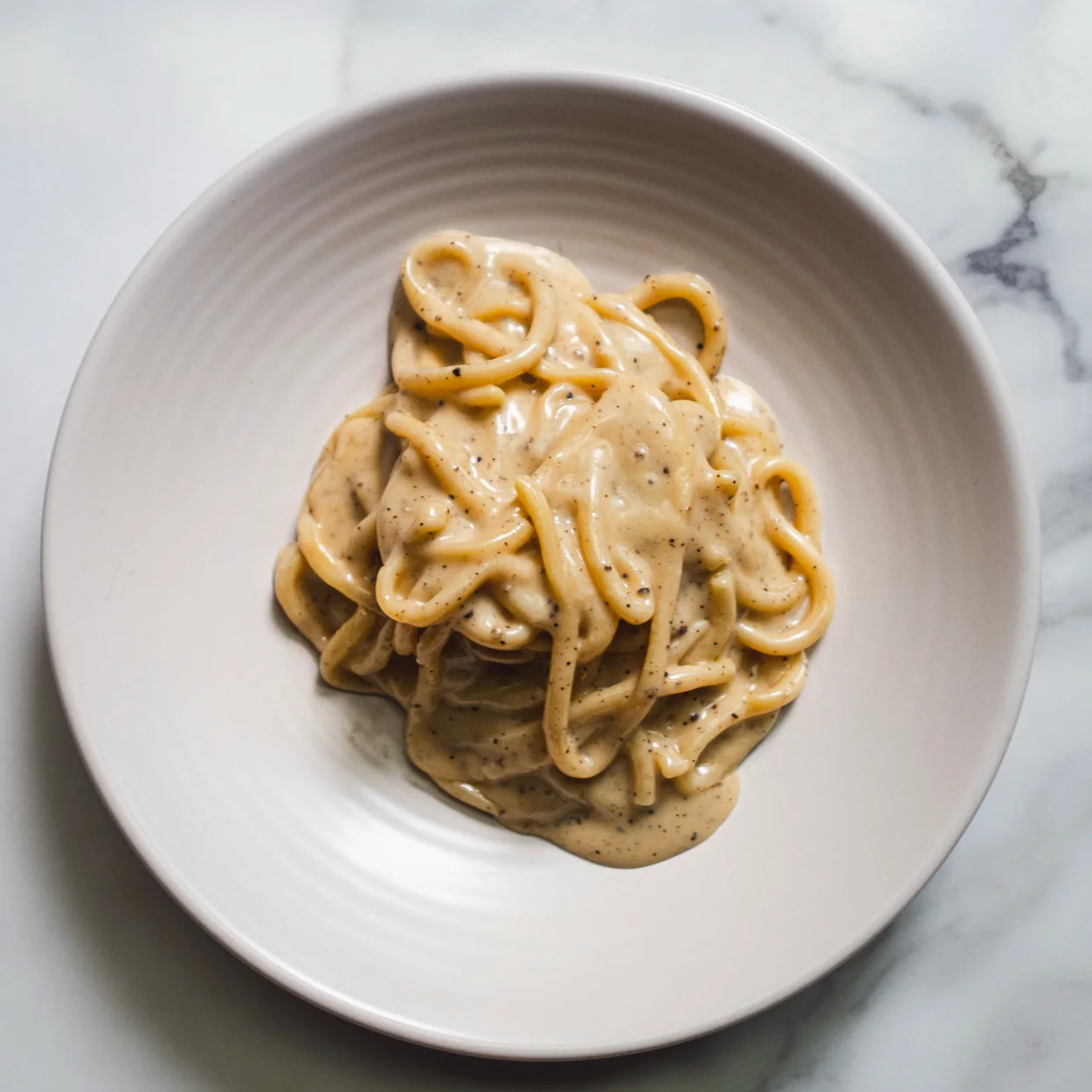 Bancone hand-rolled pici pasta in a creamy sauce