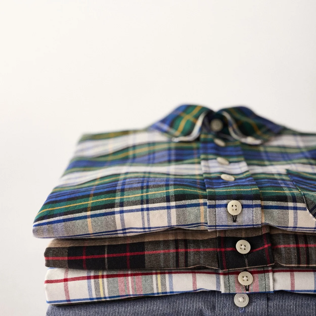 Barbour tartan and check shirts folded in a stack