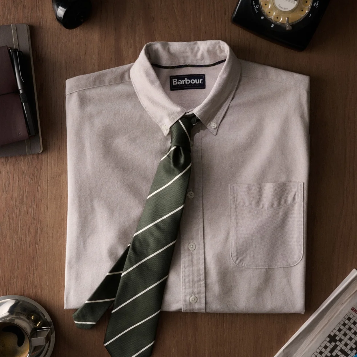 Barbour oxford shirt laid out with a striped tie