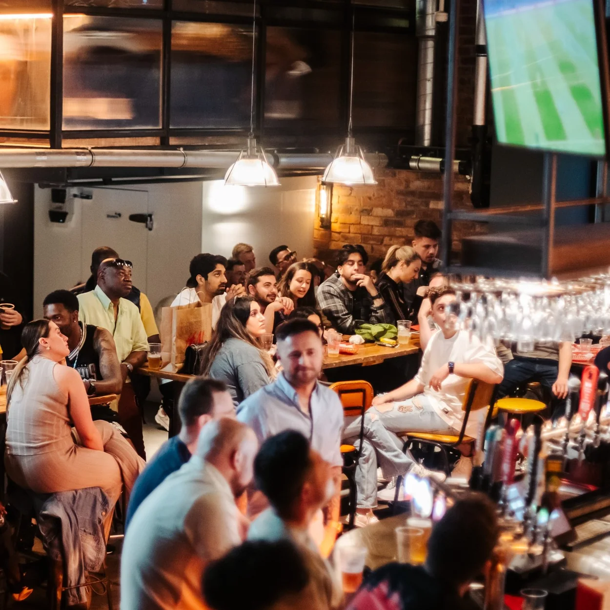 Bat & Ball bar floor with crowd watching live sport on screens
