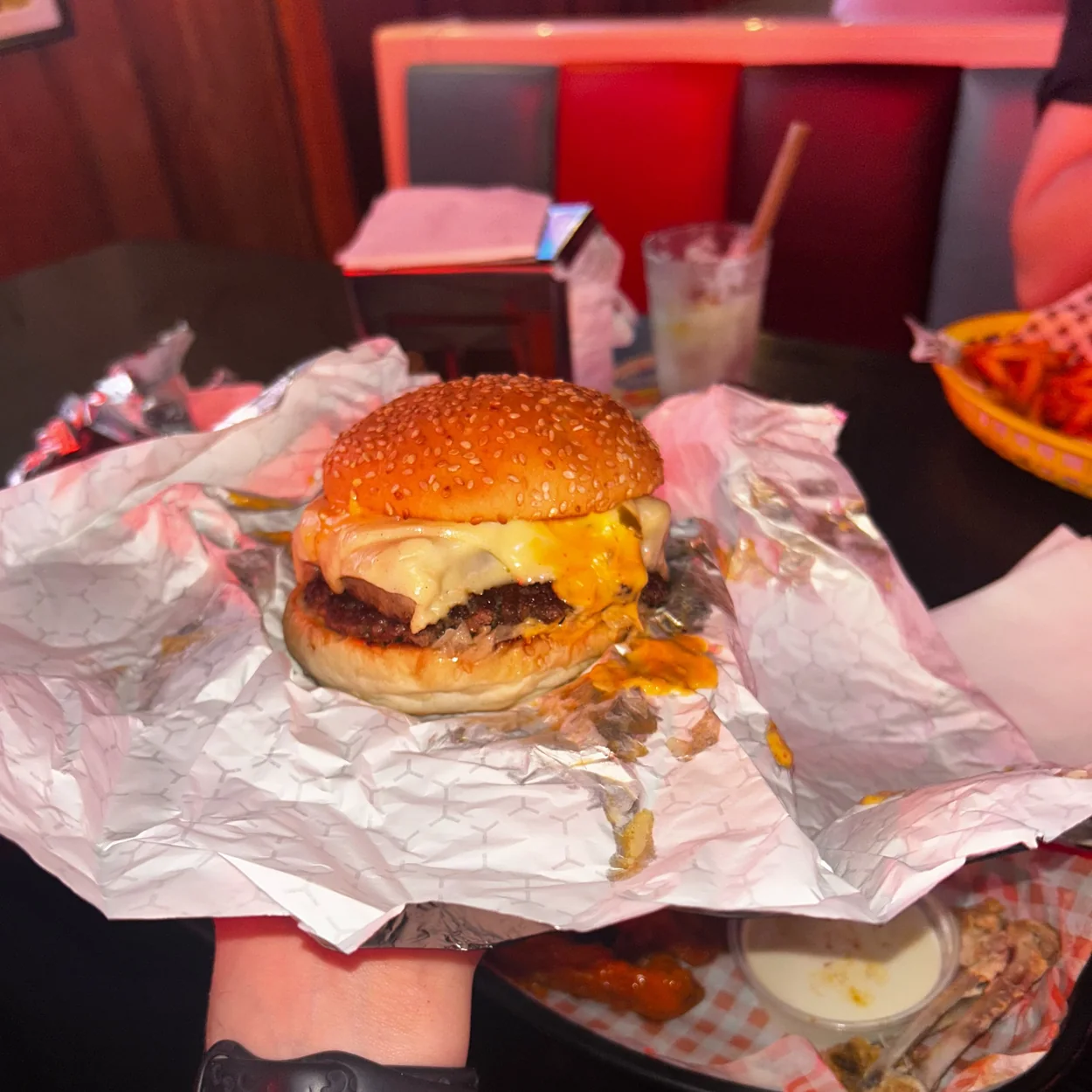 BLOODsports cheeseburger in wrapping paper at the bar