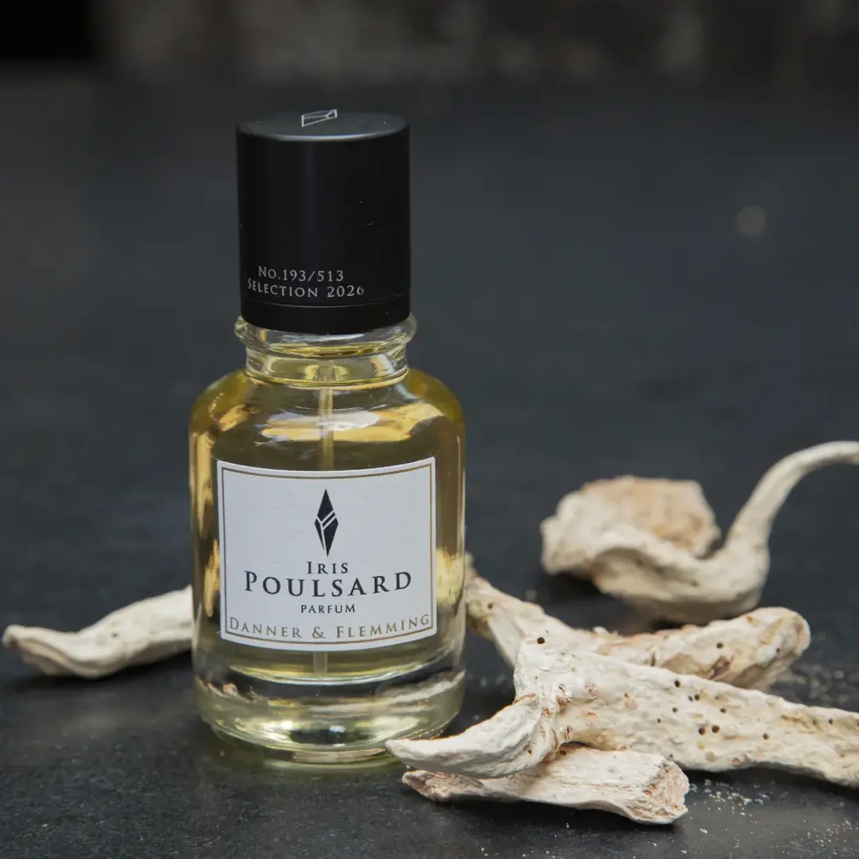 Bloom Perfumery Iris Poulsard parfum bottle on a dark surface