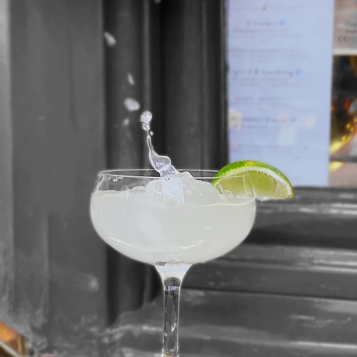 Coupe cocktail with lime by the window at Bow Street Tavern