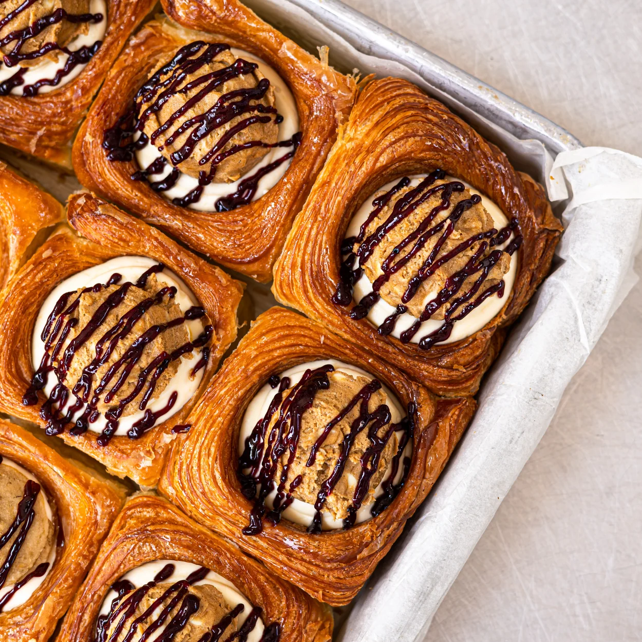 Buns From Home croissant buns filled with cream and drizzled with chocolate