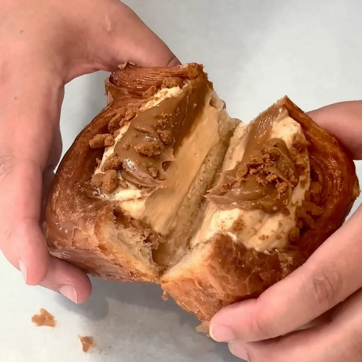 Buns From Home filled croissant bun torn open to show the layers