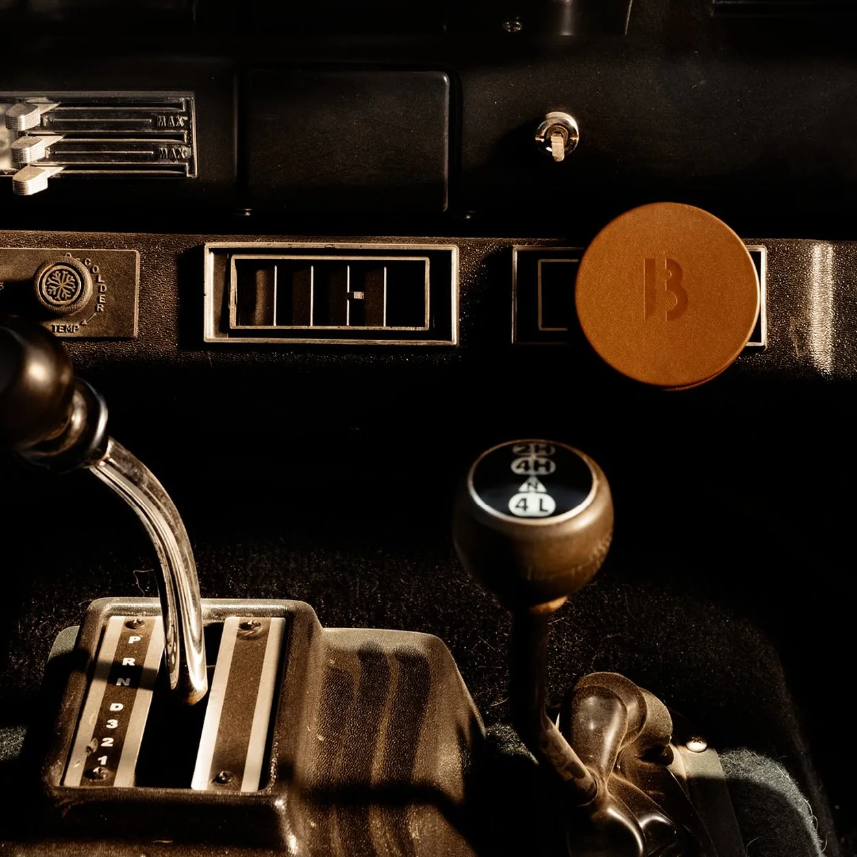 BYREDO leather key fob on a vintage car dashboard