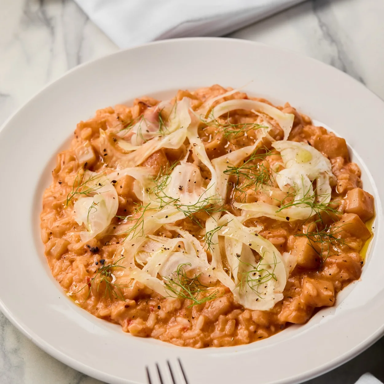 Café Murano tomato and fennel risotto on a marble table