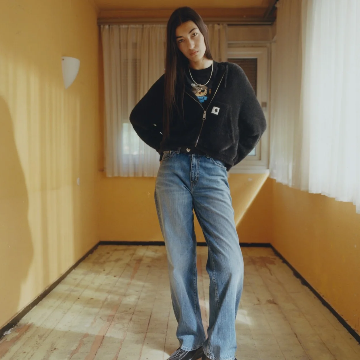 Carhartt WIP black hooded jacket and light-wash jeans