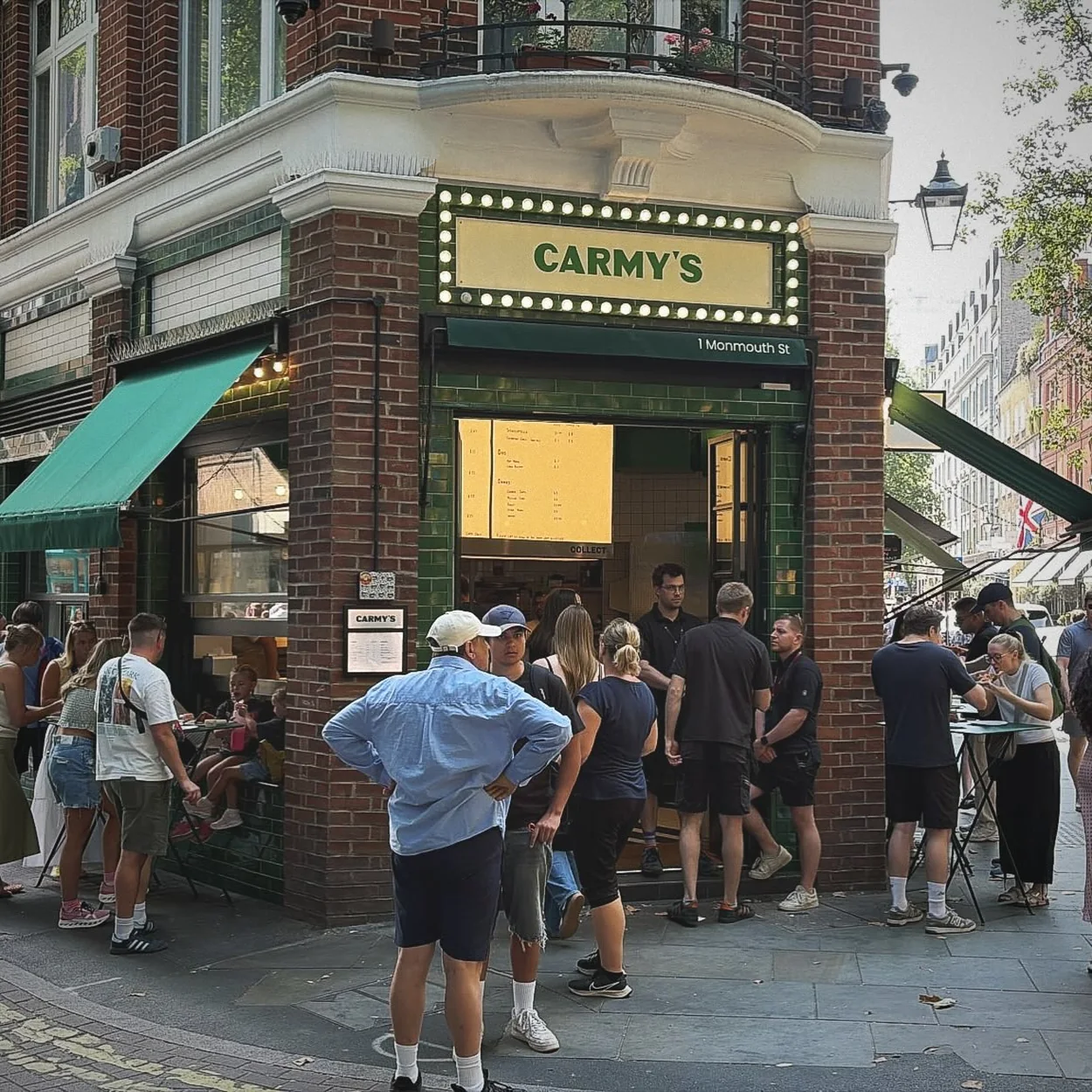 Carmy's corner shopfront with a queue on Monmouth Street