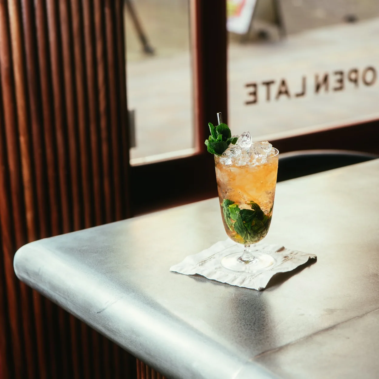 Cato bar counter with a mint cocktail by the Open Late window on Mercer Street