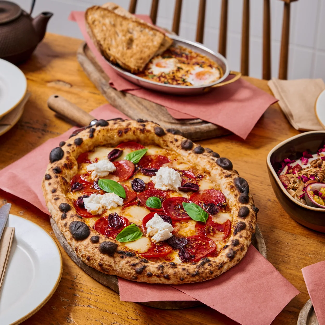 Chestnut Bakery table spread with pizza, pastries and coffee