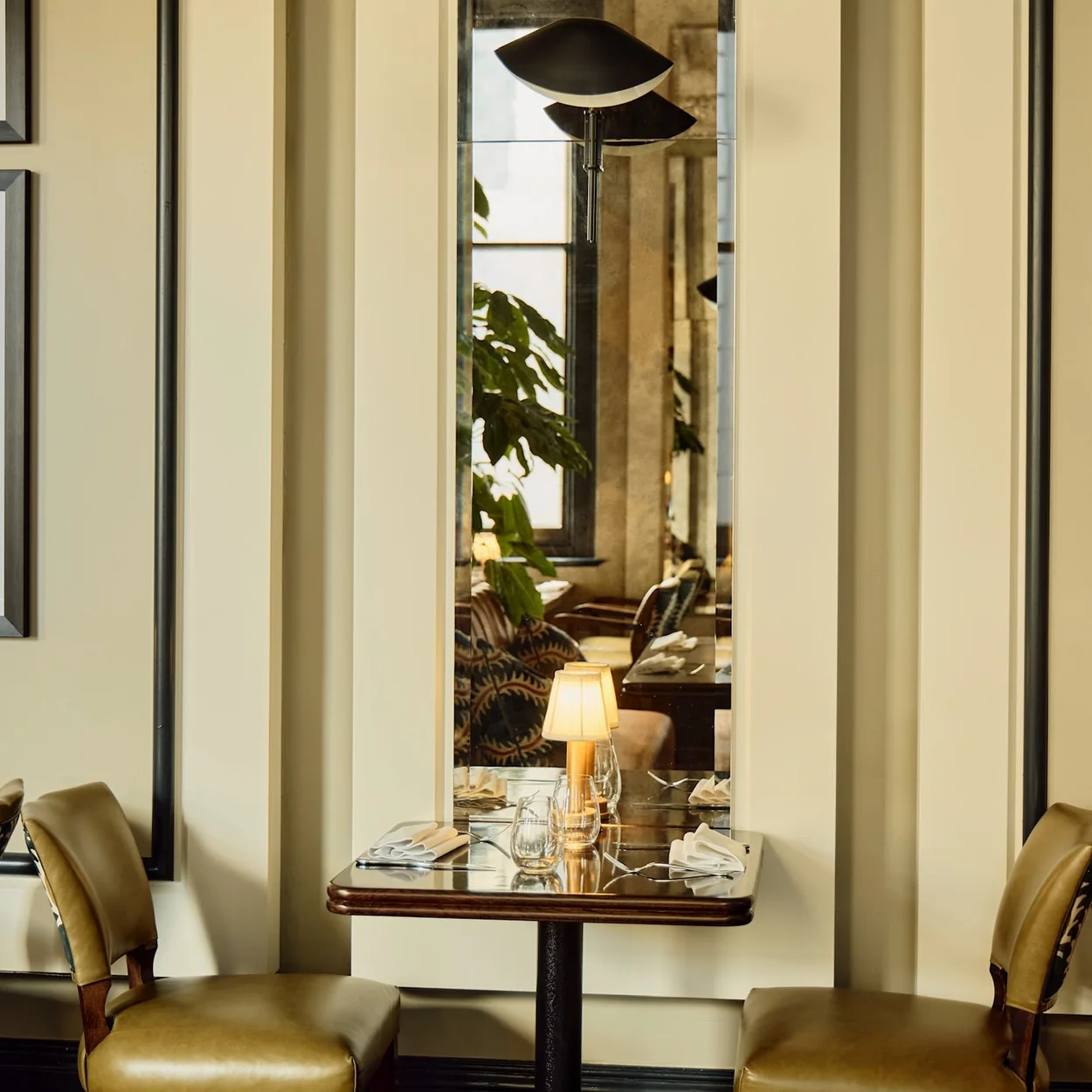 Christopher's dining room with a candlelit table for two by the tall windows