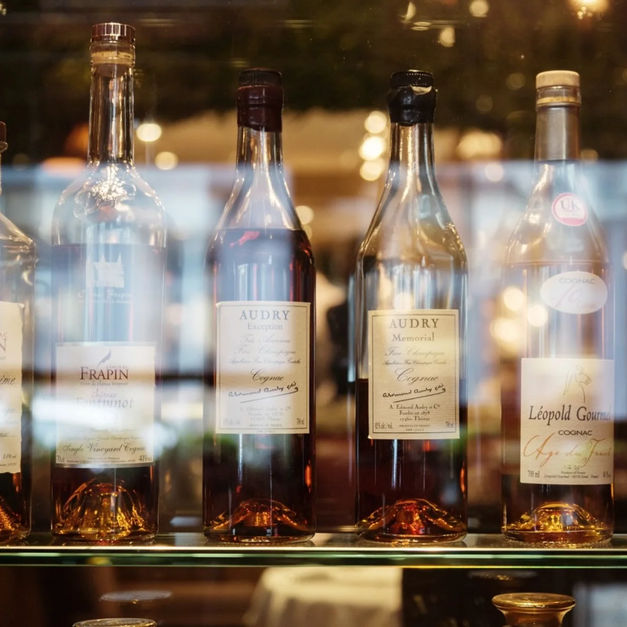 Clos Maggiore aged spirits and cognac bottles on the back bar