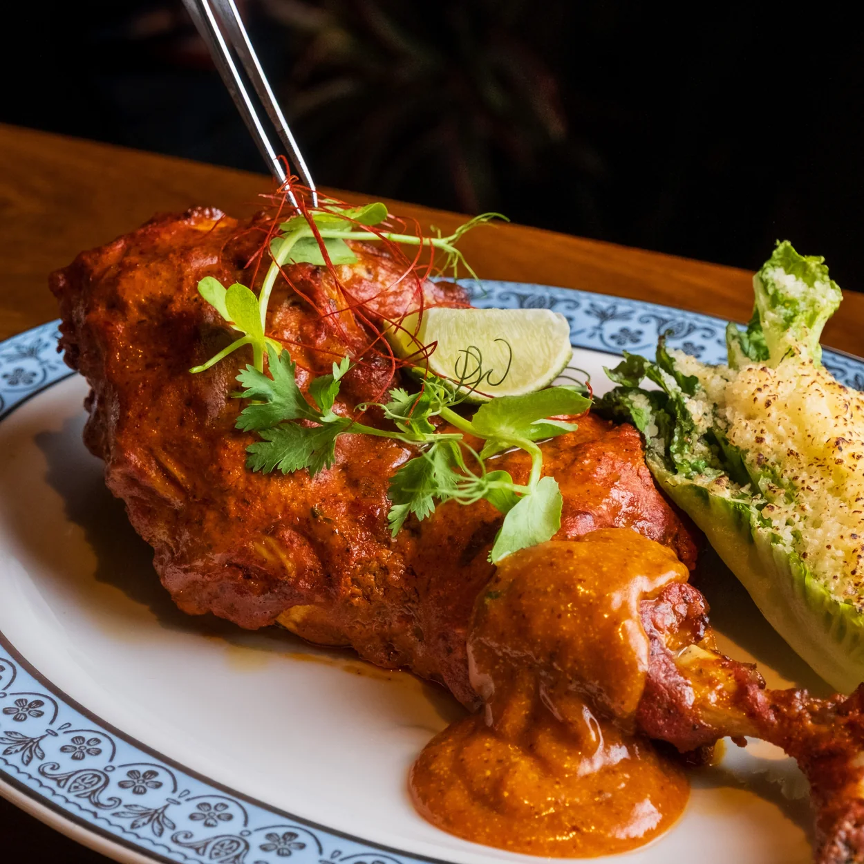 Colonel Saab tandoori chicken with sauce and lime