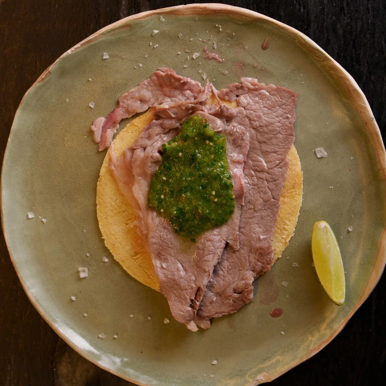 Condesa tapas, sliced beef on a tostada with salsa verde
