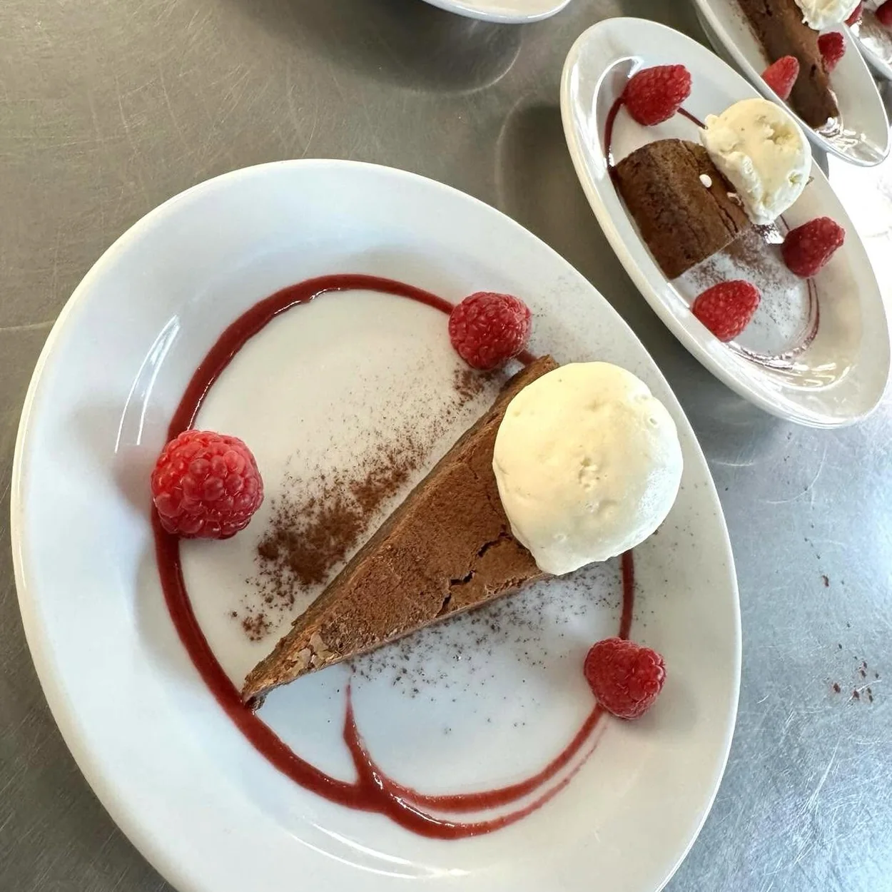 Cork & Bottle chocolate tart dessert with ice cream and raspberries