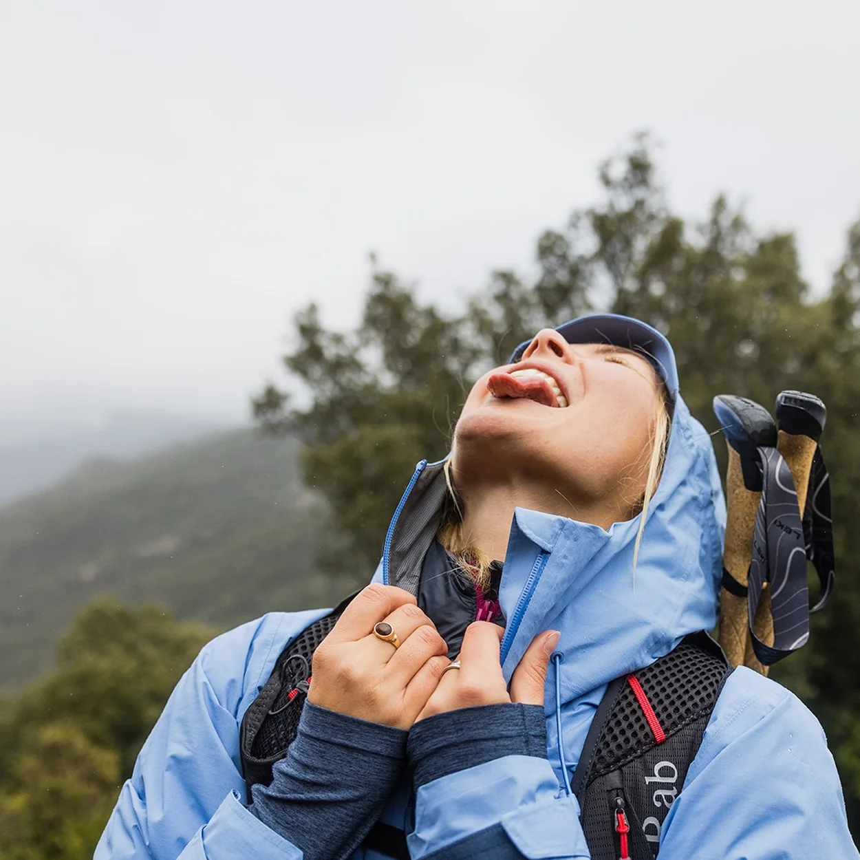 Cotswold Outdoor blue insulated jacket worn on a hill walk with trekking poles