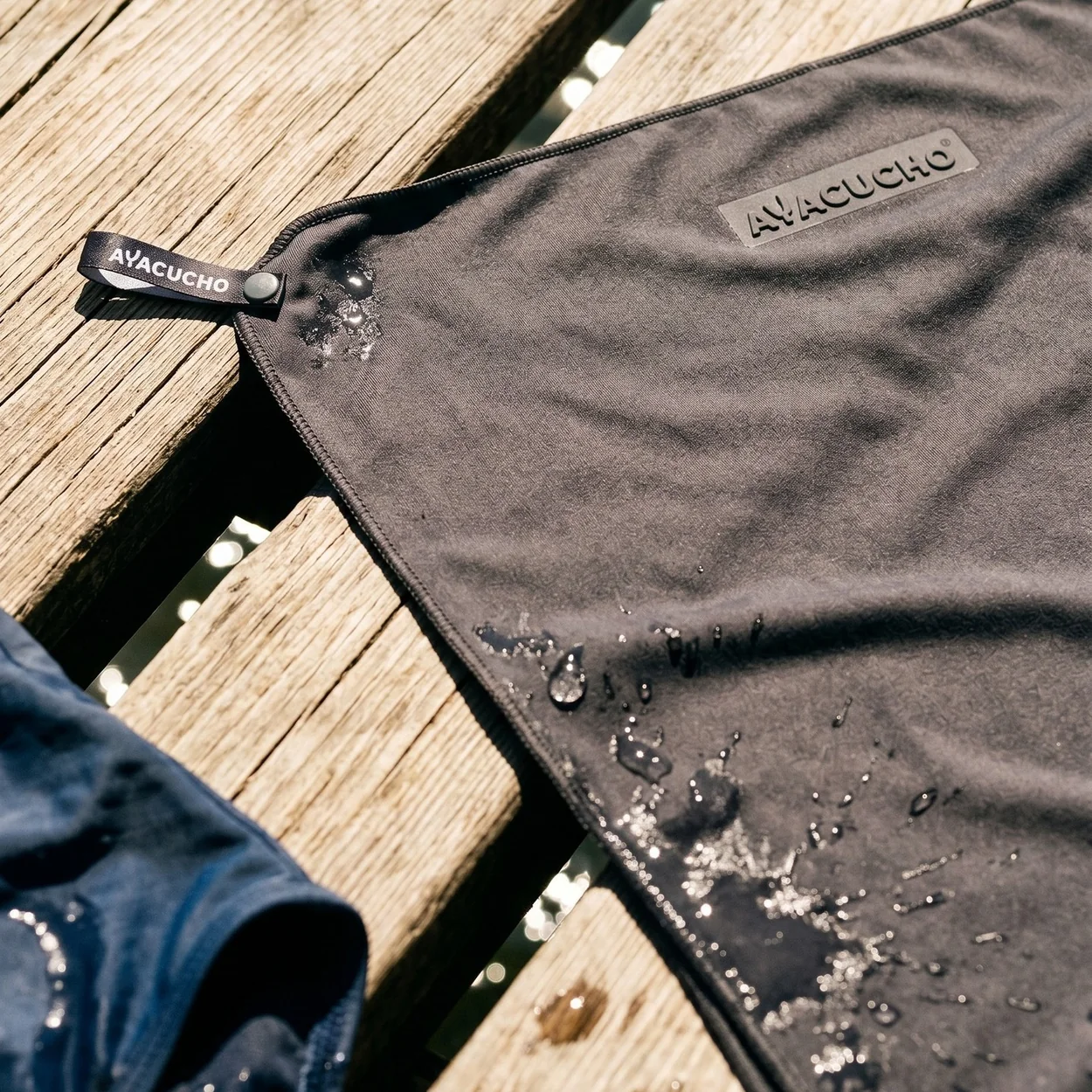 Cotswold Outdoor Ayacucho waterproof fabric beading rain on a wooden deck