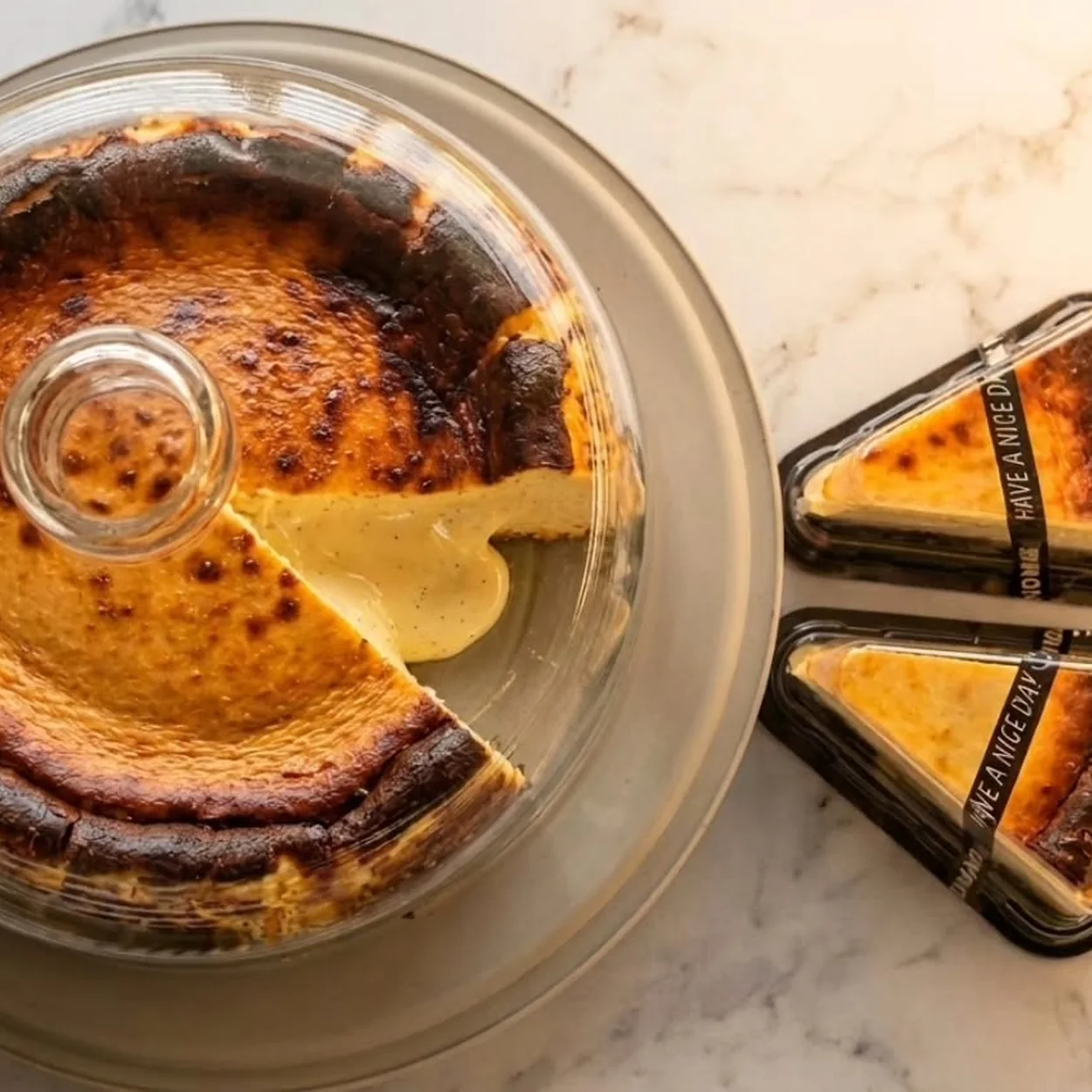 Day Day Drink burnt Basque cheesecake and cut slices on a marble counter