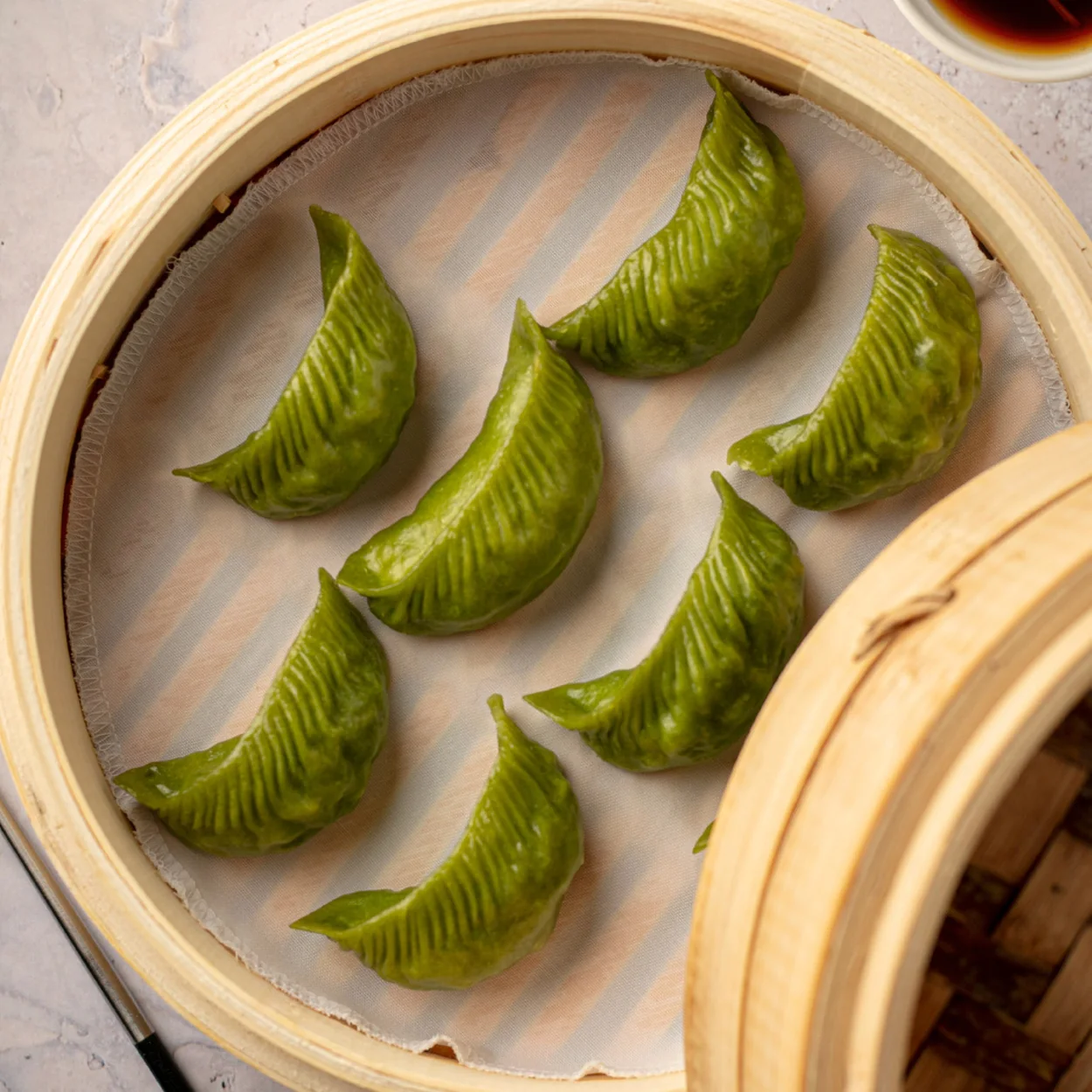 Din Tai Fung green vegetable dumplings in a bamboo steamer