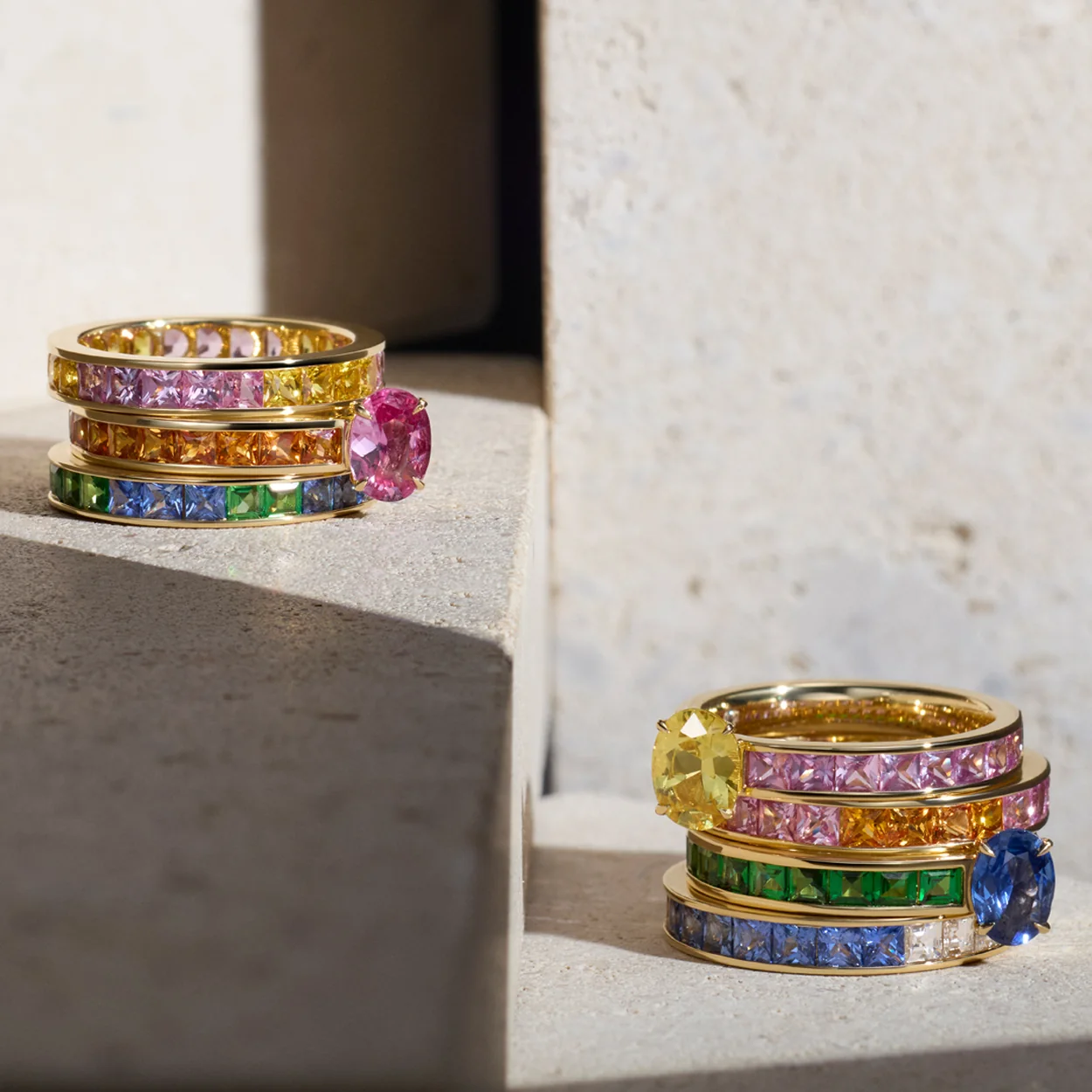 Dinny Hall gold rings with rainbow sapphires on stone
