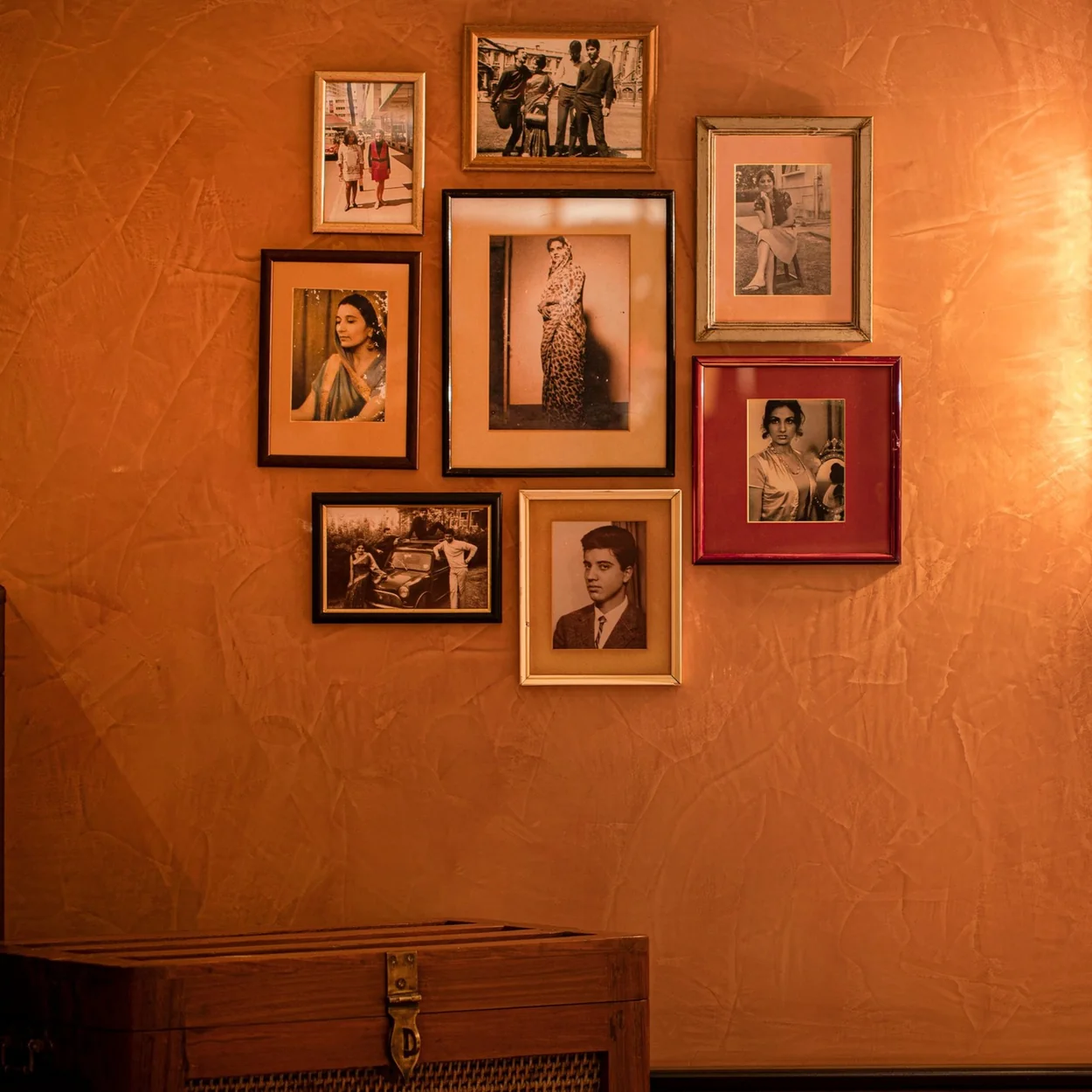 Dishoom Covent Garden wall of framed Bombay photographs above a leather banquette