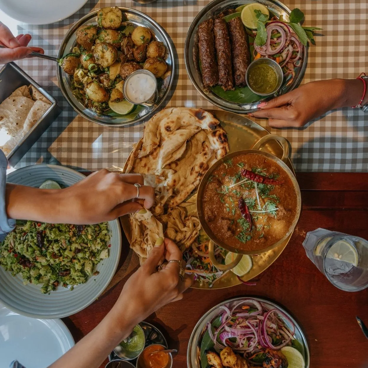 Dishoom Covent Garden sharing feast of kebabs, naan, daal and salads