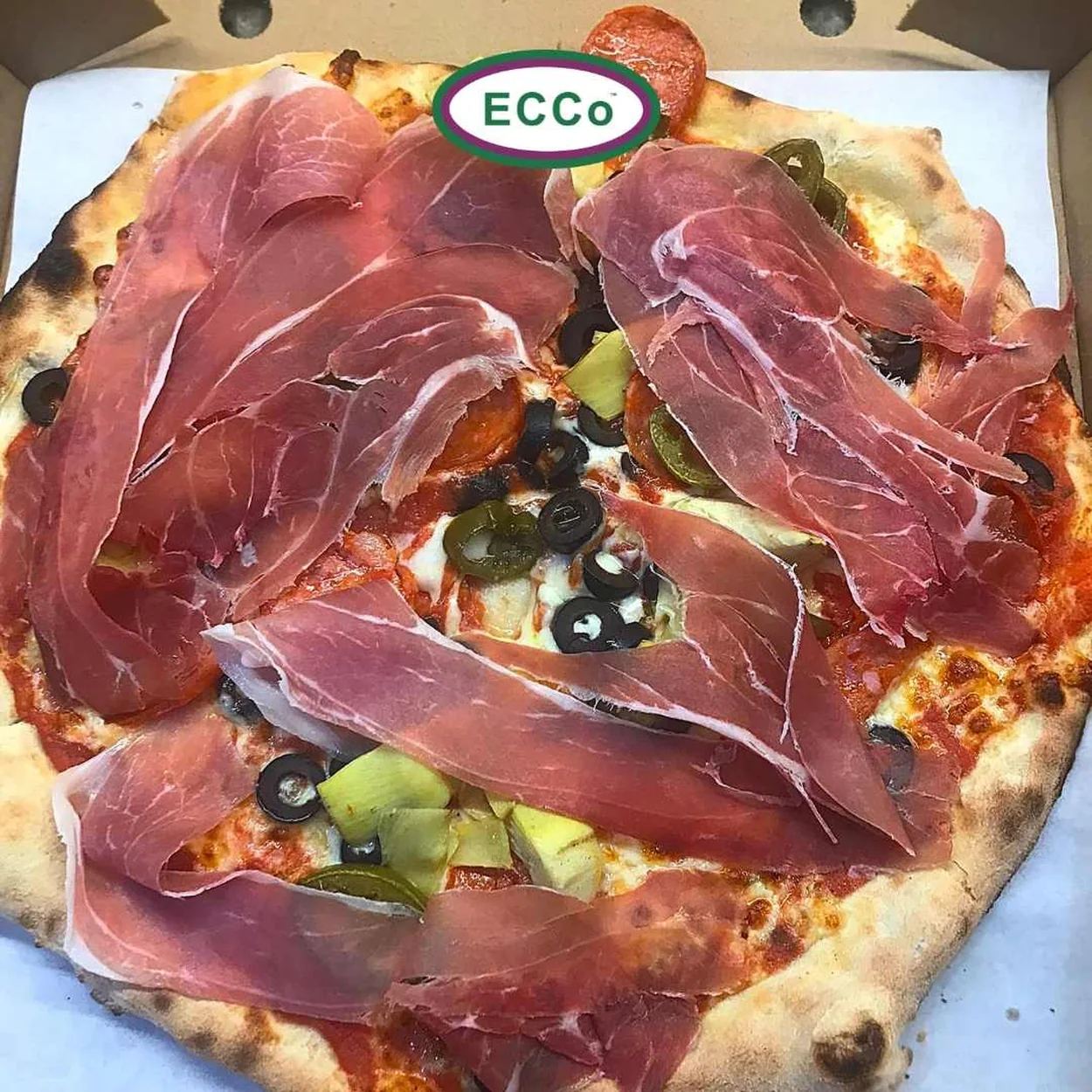 Ecco Pizza with Parma ham and olives in a takeaway box