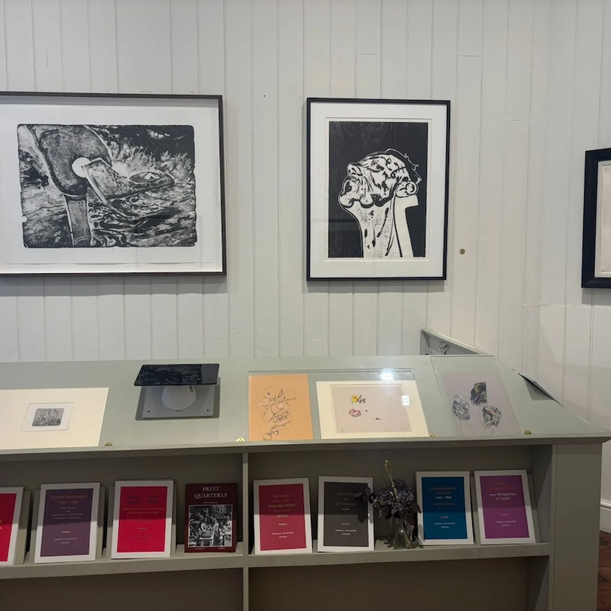 Emanuel von Baeyer display of framed works on paper above a cabinet of catalogues