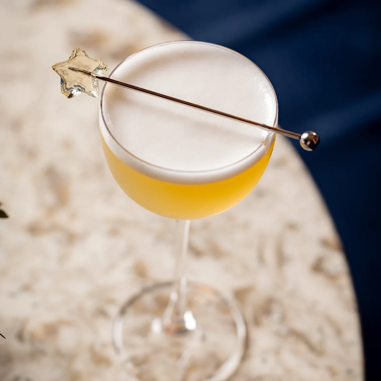 Eve Bar Covent Garden, a golden sour-style cocktail on a marble table