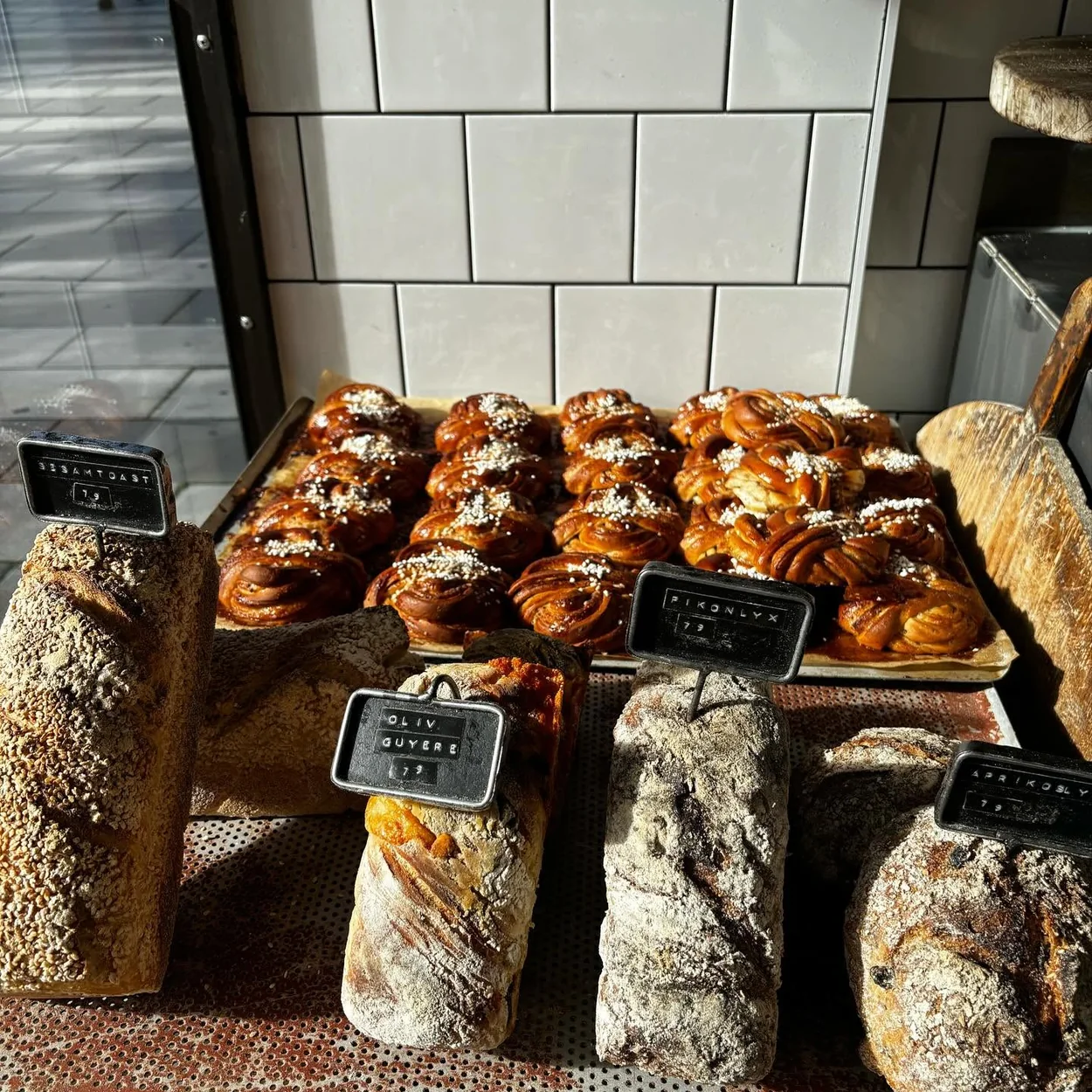 Fabrique bakery counter with cinnamon buns and sourdough loaves