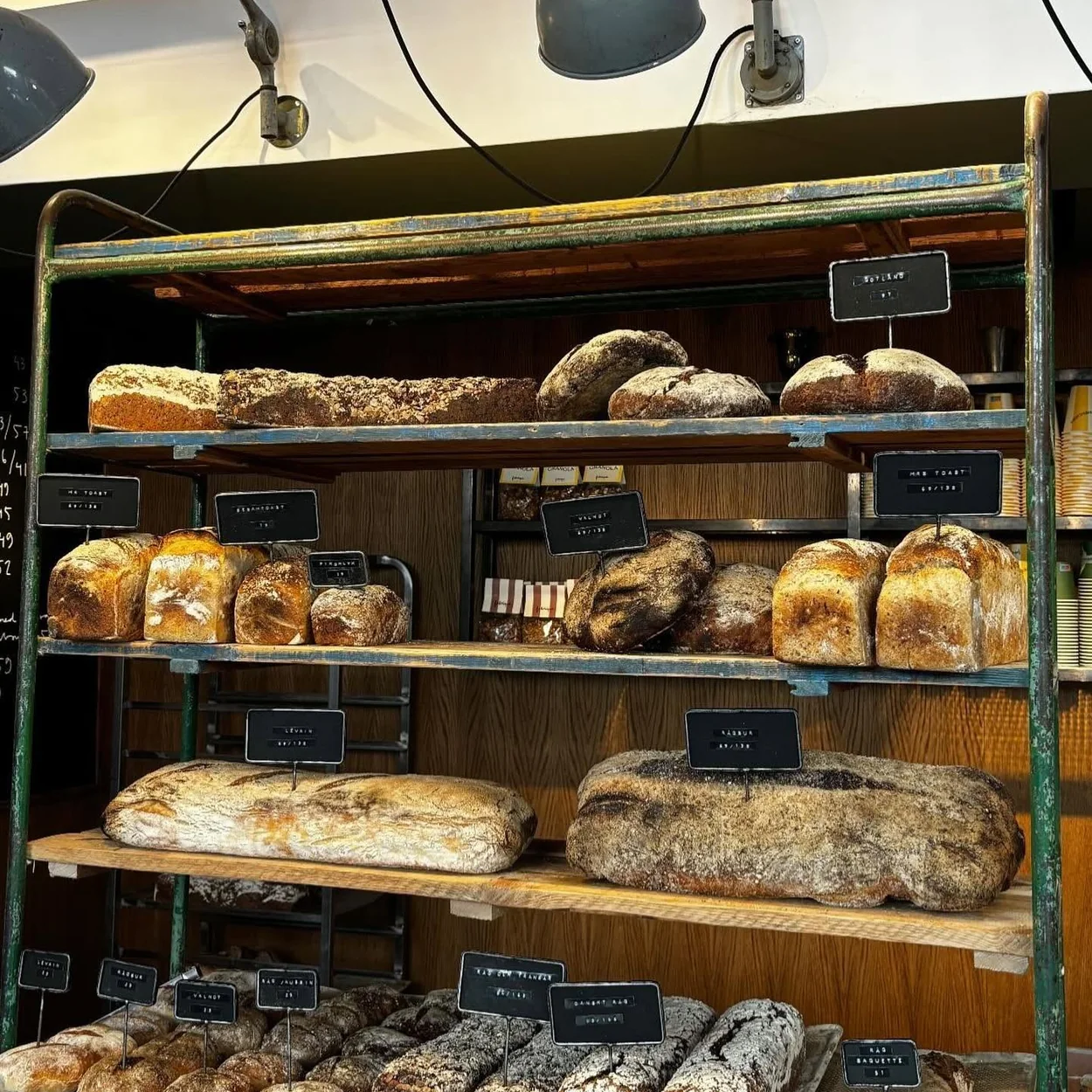 Fabrique bread shelves stacked with sourdough loaves
