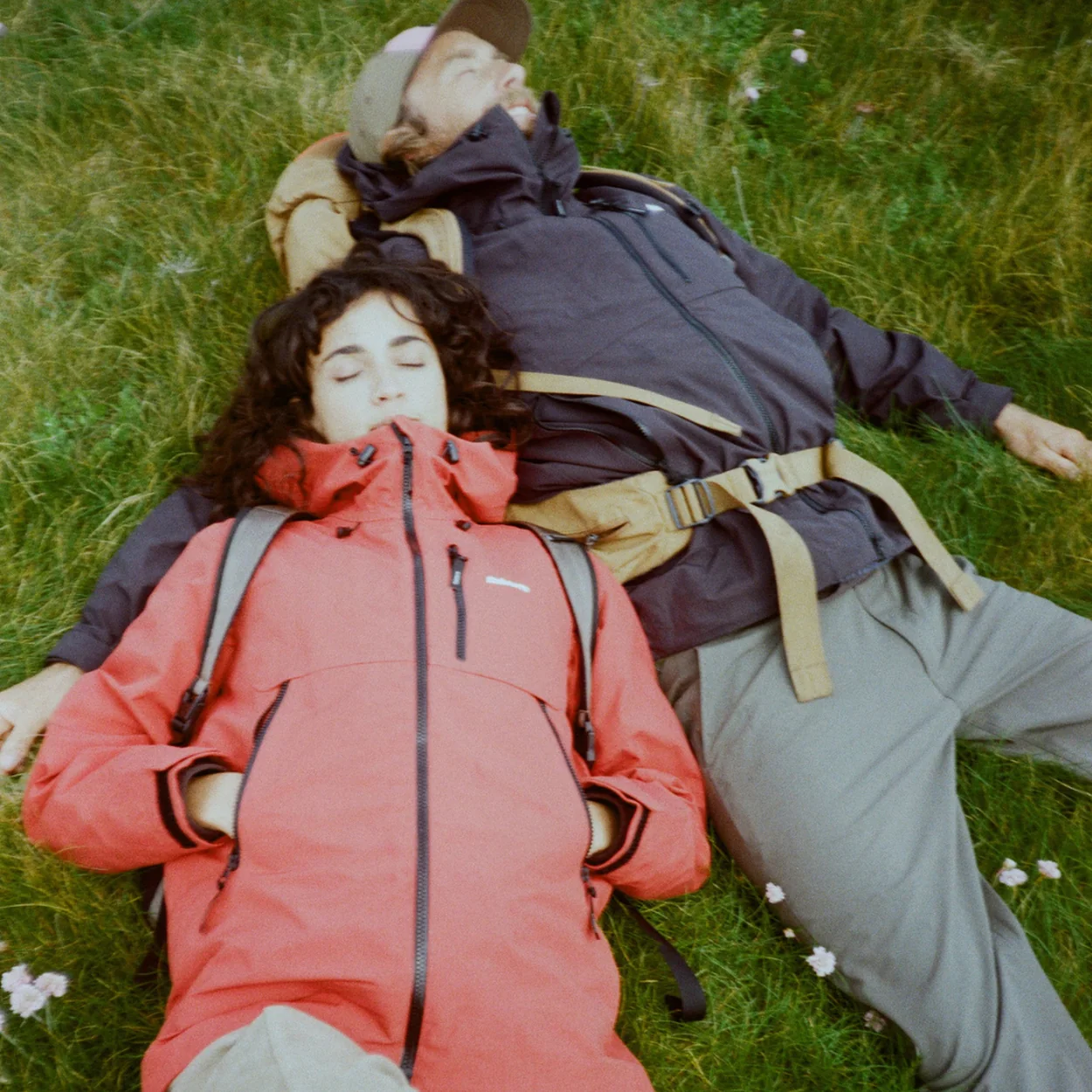 Finisterre waterproof jackets worn lying on grass
