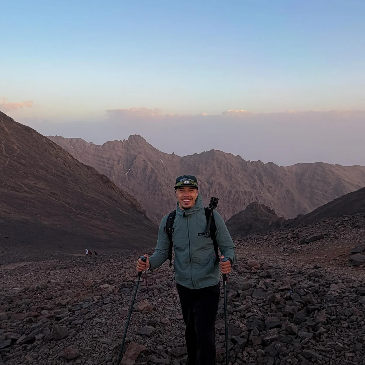 Finisterre hiking jacket worn on a mountain ridge at dusk