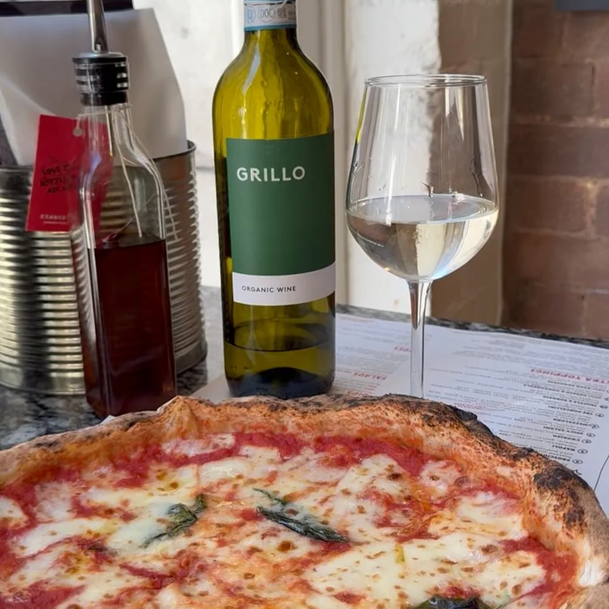 Franco Manca Covent Garden sourdough pizza with a glass of white wine